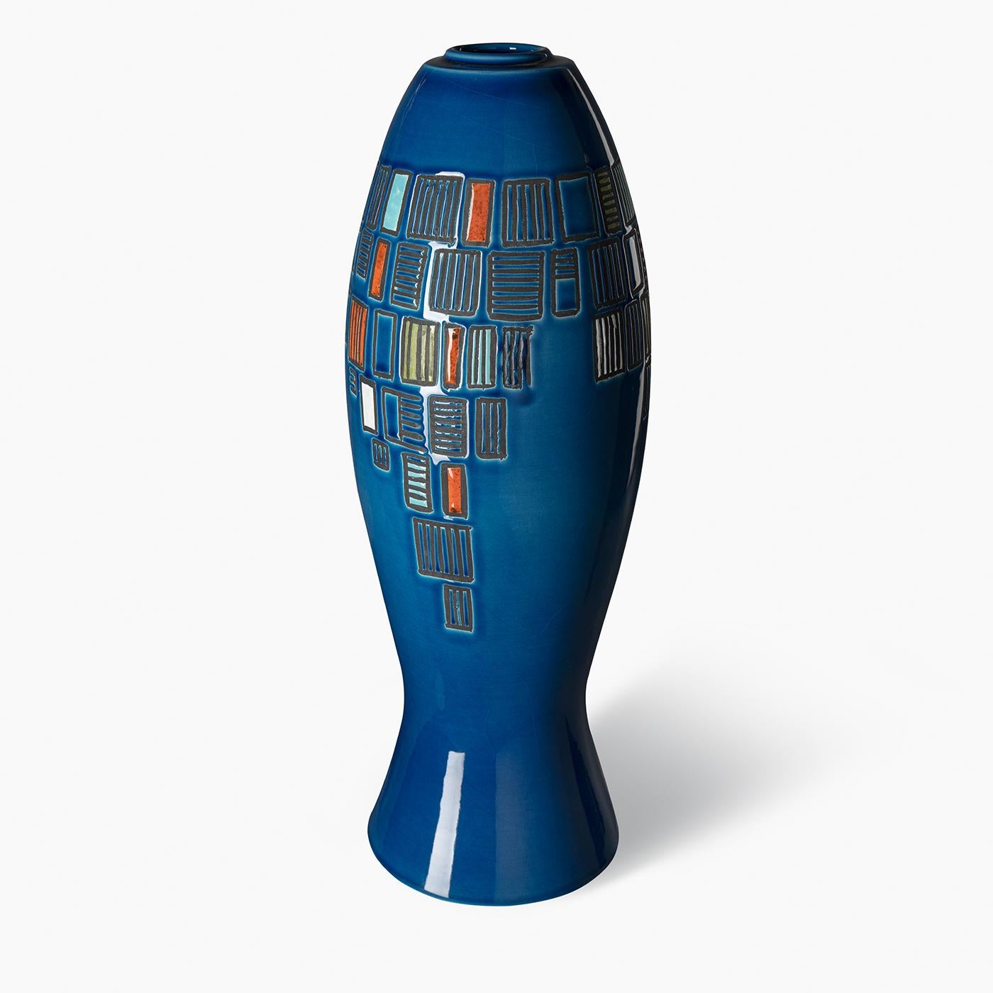 This medium-sized decorative vase features a blue egizio background with geometric sections colored in shades of orange, white, and green. The design draws inspiration from the abstract painter Giuseppe Capogrossi, executed with liquid wax