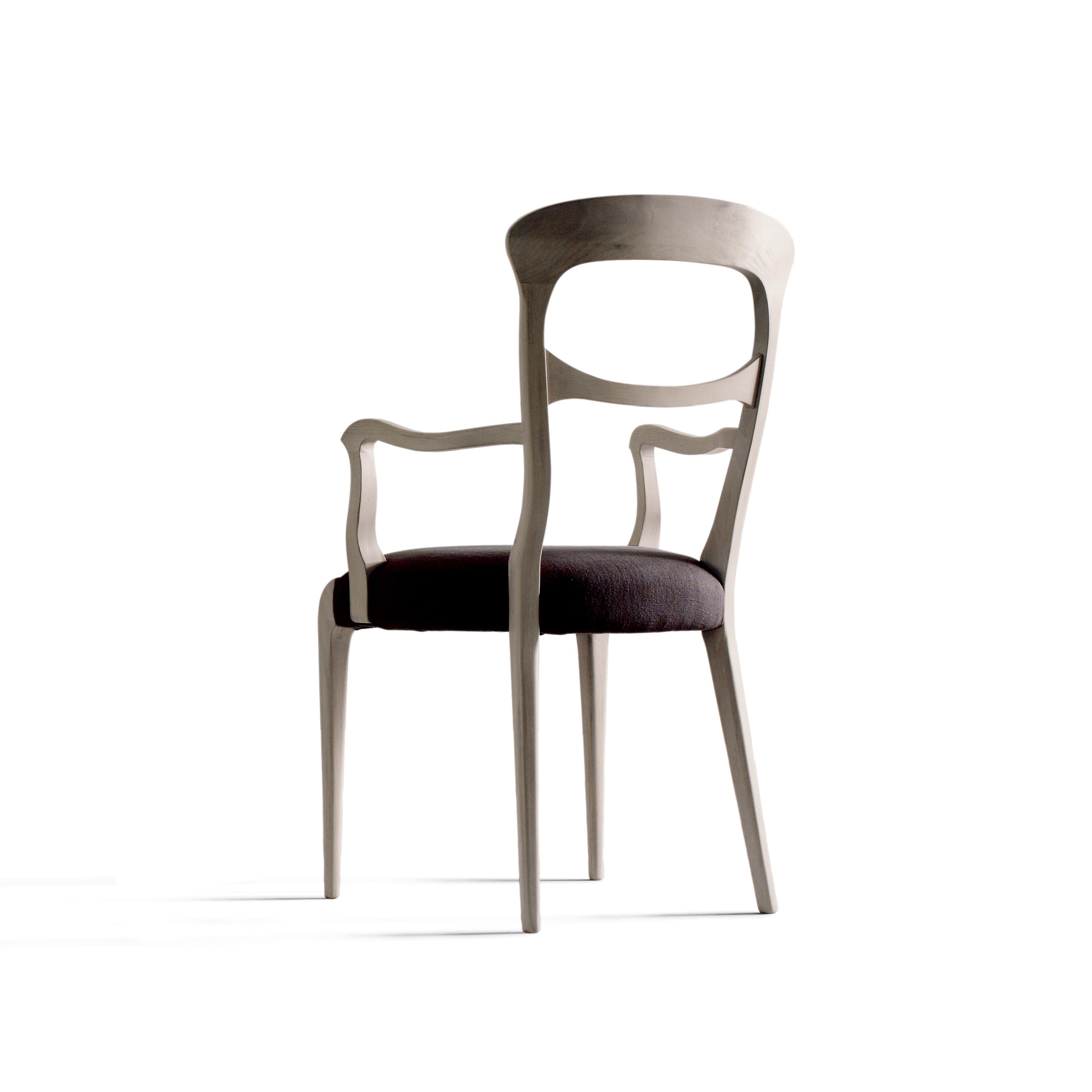 The Capotavola solid wood chair embodies the refined elegance of Italian design. Made in Italy by hand, it features solid canaletto walnut structure with acrylic finish and lining in premium leather or fabric in a range of different colors.