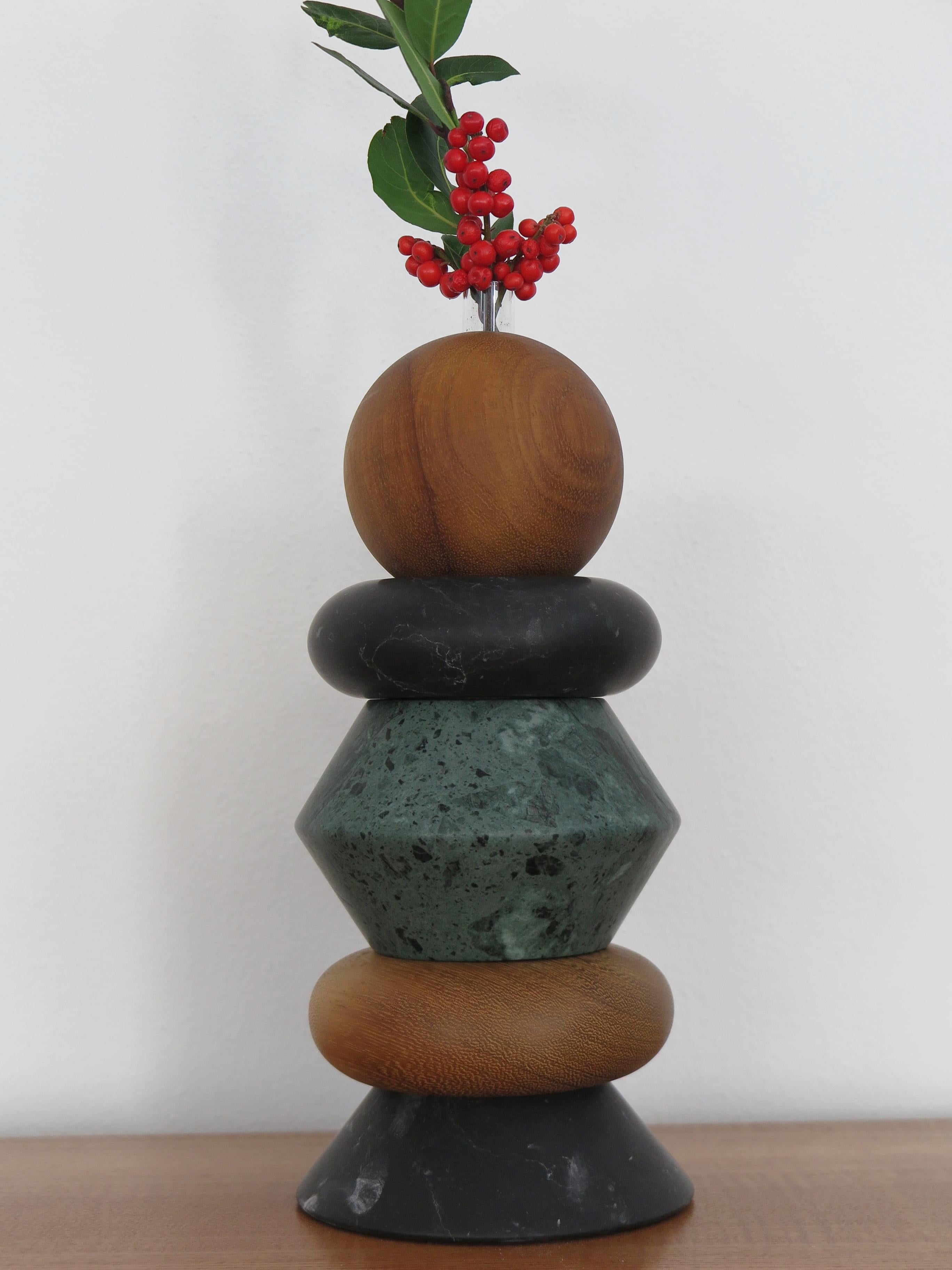 Italian contemporary sculpture, candle holder and flower vase, modular as you like made up of green Alpi marble, black marble, and solid wood with including two glass vases for fresh flowers.
The various elements can be composed and stacked as