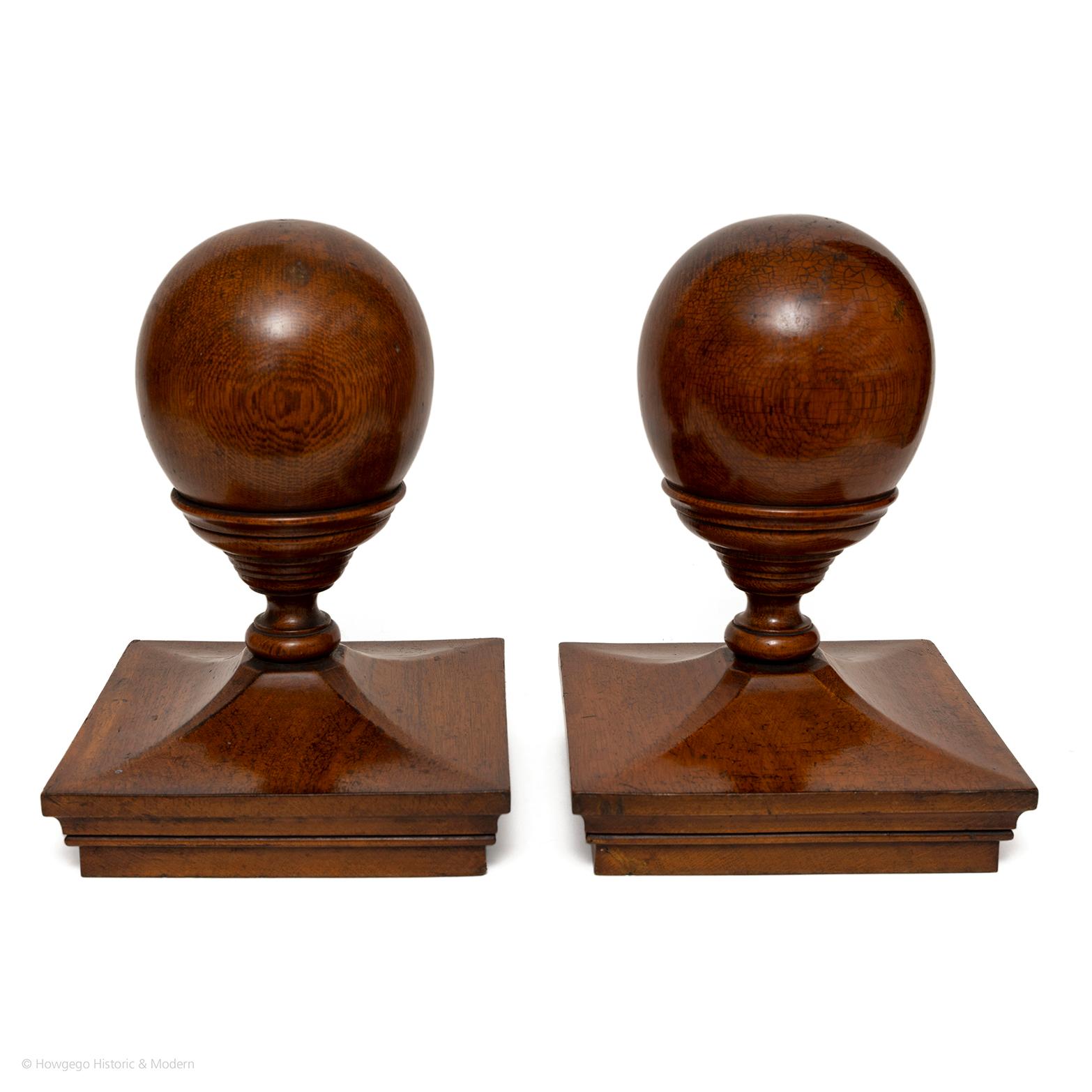 Rare pair of oak newel post cappings or finials
Elegant and finely turned ball supported cup sweeping into deep moulded base
Made from high quality oak with fine figuring
Original lustrous patina
Could be repurposed as decorative objects or