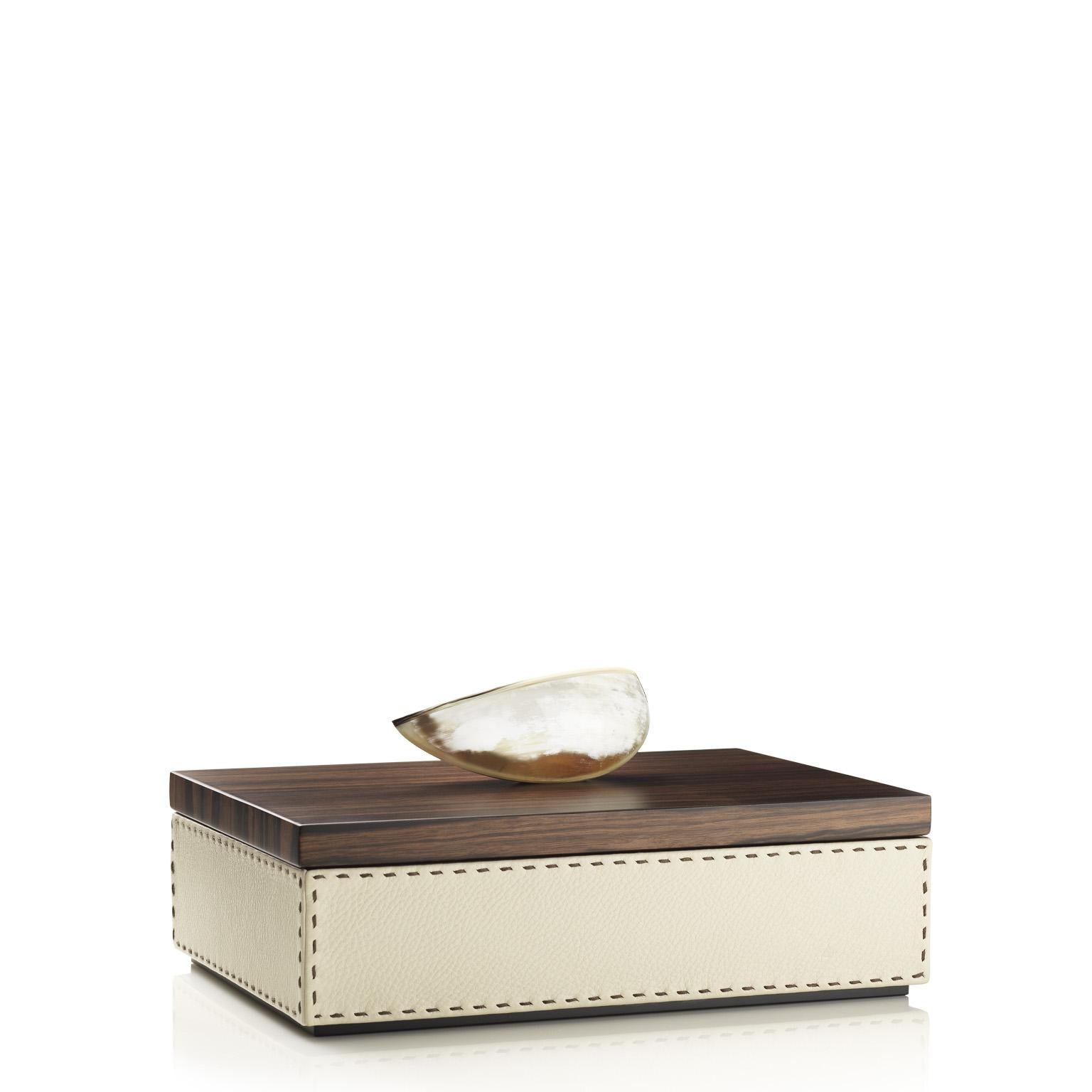 Befitting of all decor, the Capricia rectangular box will be a unique addition to your vanity station or to any other place in your home and office. Clad in Aida pebbled leather in a natural Ice-cream colour, Capricia sports a dark brown handmade