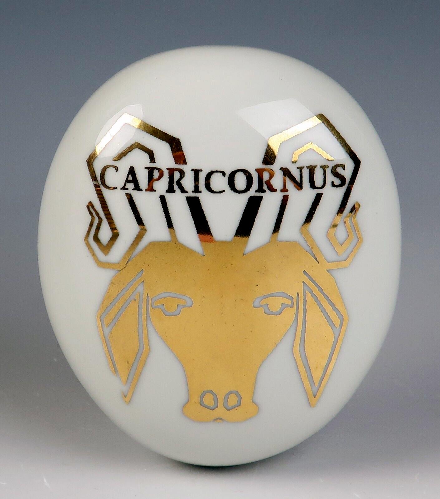 Piero Fornasetti Ceramic Pebble Capricorn Zodiac Paperweight,
Titled Capricornus for the Astrological Sign Capricorn,
Circa 1960 

The oval ceramic paperweight is made in a form called pebble by Fornasetti.  The top depicts, in gold, a goat with the