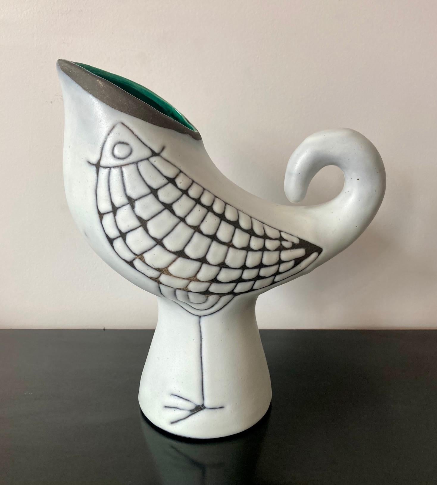 Ceramic vase / pitcher, thick white enamel with a bird motive on each side.
Green enameled collar.
A rare and attractive decor particularly well adapted to the zoomorphic shape of the vase. 

Measures: Height : 23,2 cm (9.1 in.)
Width : 13 cm