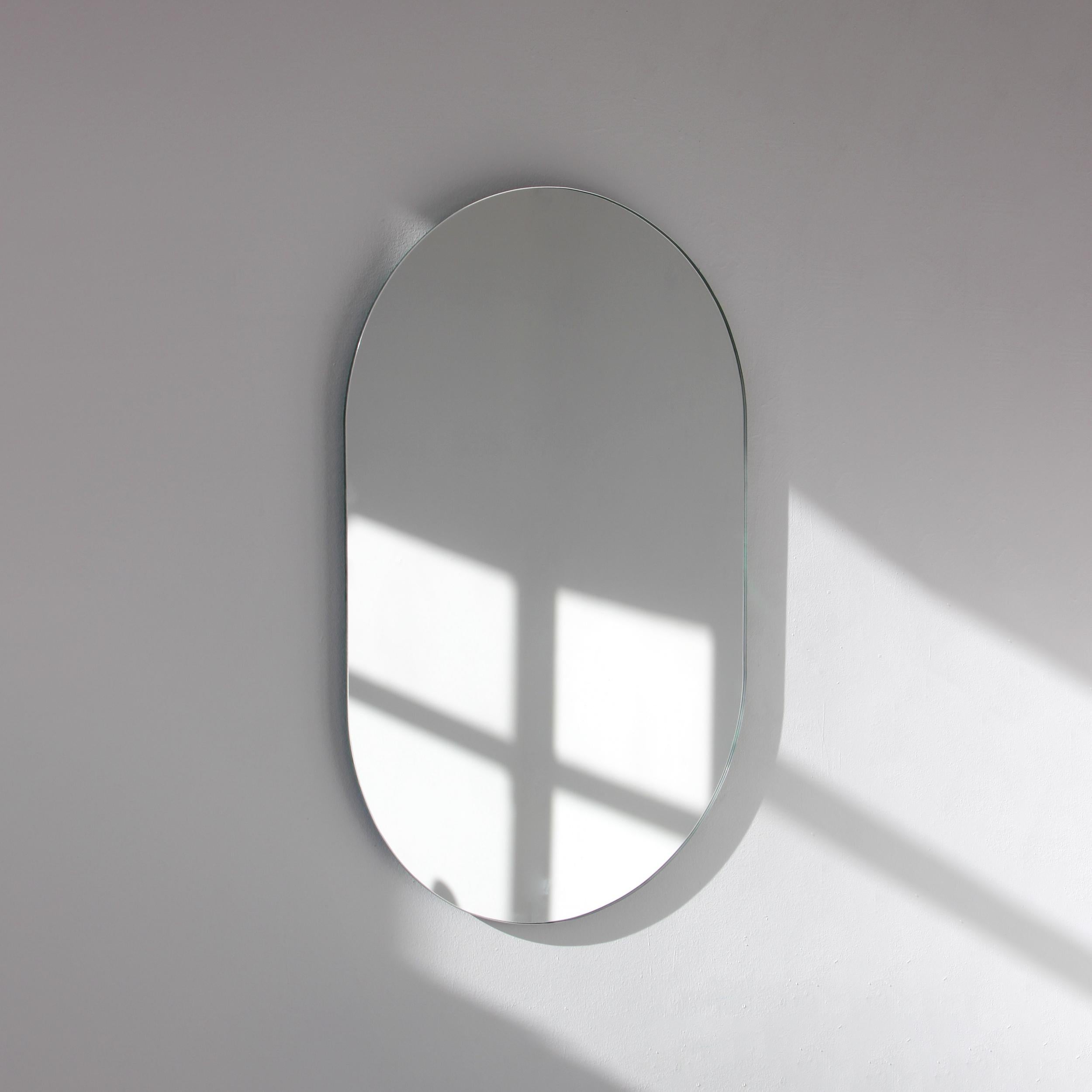 Minimalist capsule shaped frameless mirror. Quality design that ensures the mirror sits perfectly parallel to the wall. Designed and made in London, UK.

Fitted with professional plates not visible once installed for an easy and safe installation.