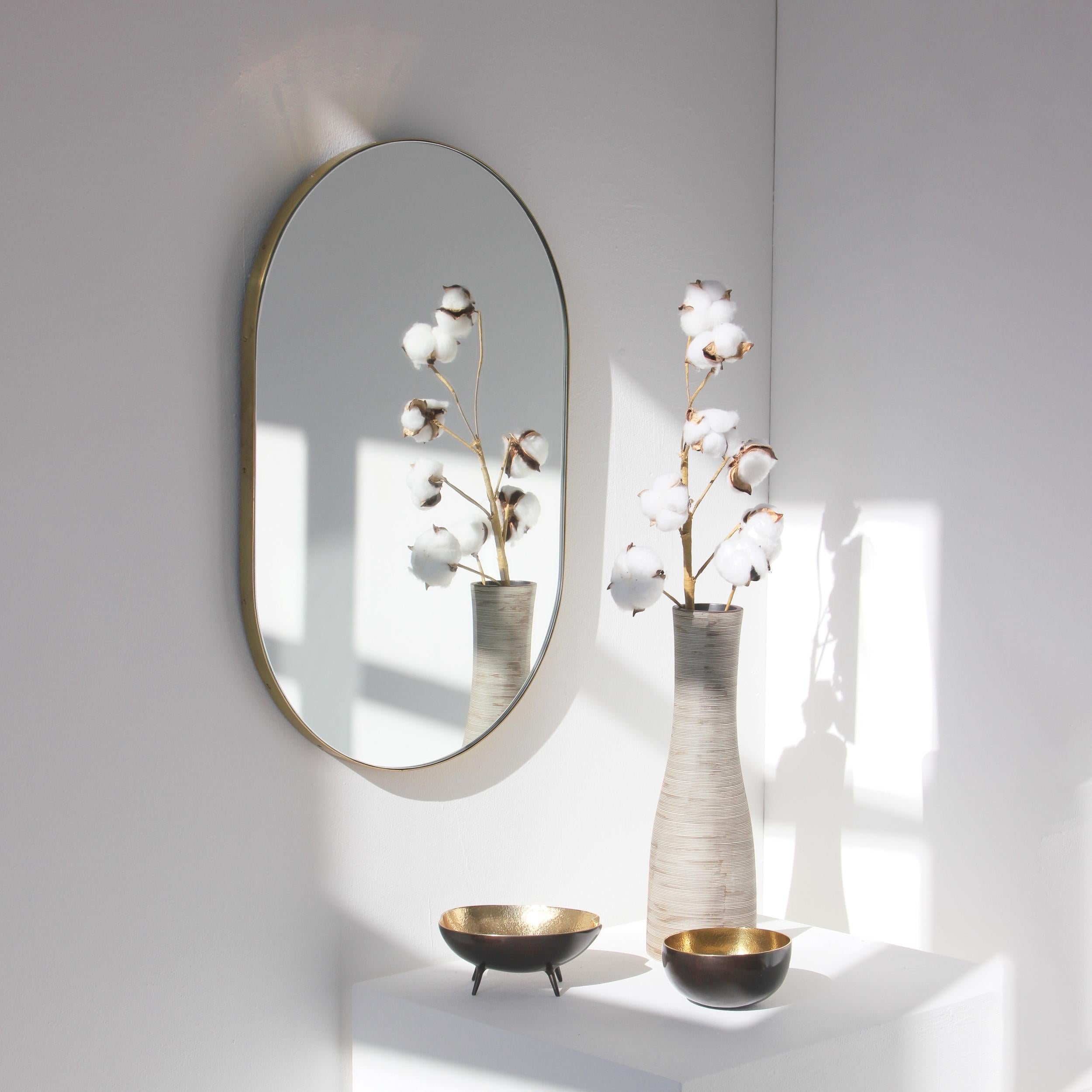 Delightful handcrafted capsule shaped mirror with a solid brushed brass frame. Designed and handcrafted in London, UK.

Medium, large and extra-large (37cm x 56cm, 46cm x 71cm and 48cm x 97cm) mirrors are fitted with an ingenious French cleat (split