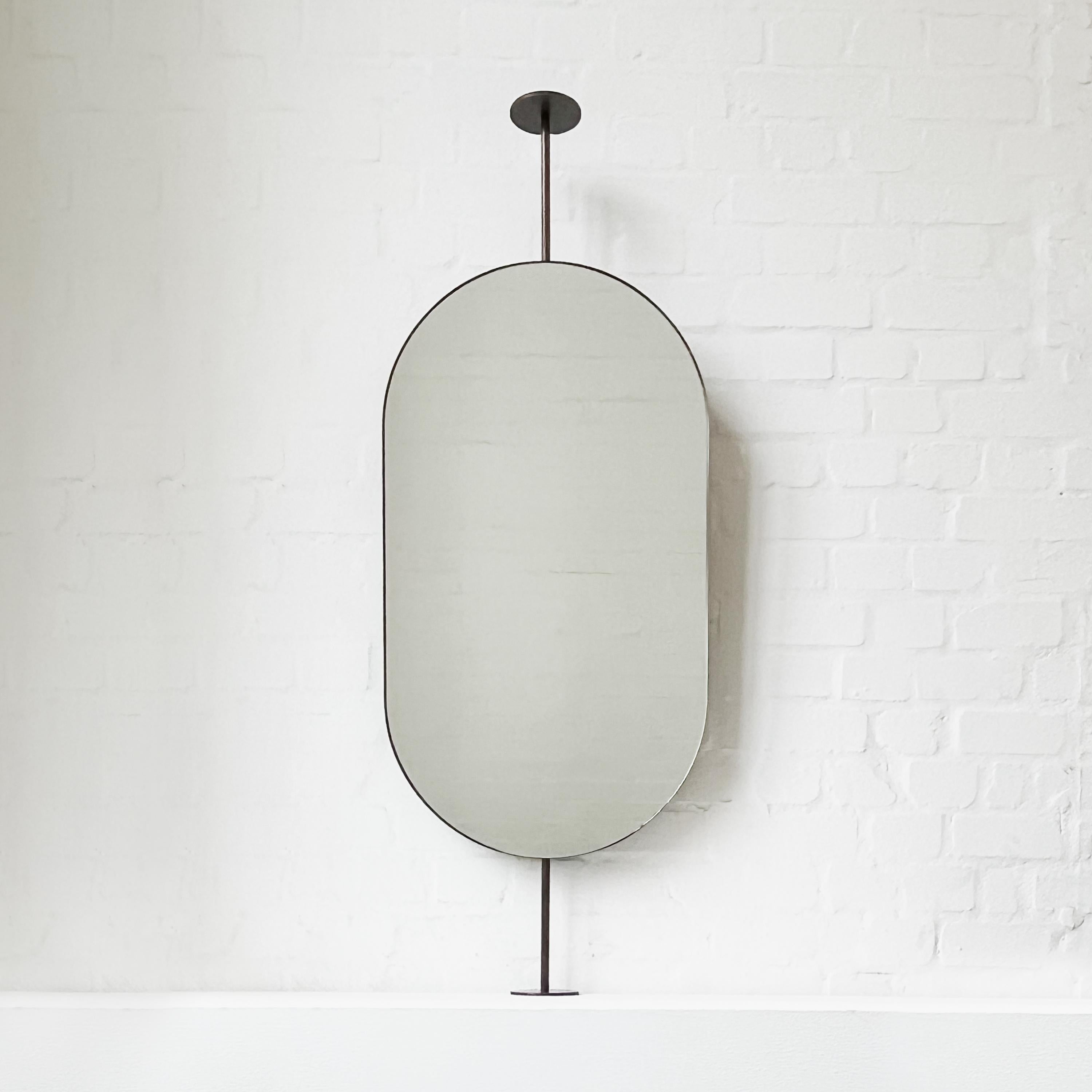 British Capsula Countertop to Ceiling Attached Pill shaped Mirror, Bronze Patina Frame For Sale