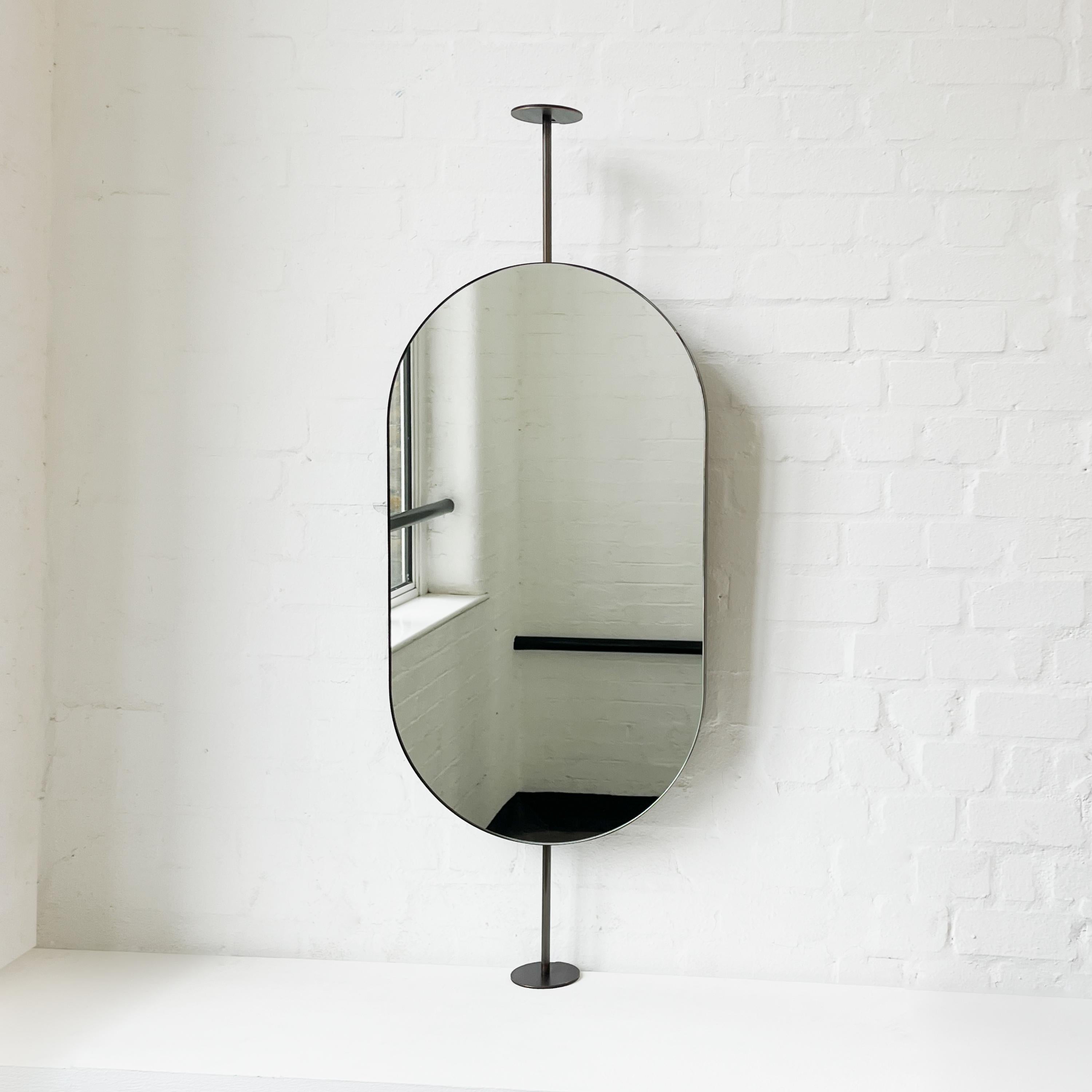 Patinated Capsula Countertop to Ceiling Attached Pill shaped Mirror, Bronze Patina Frame For Sale