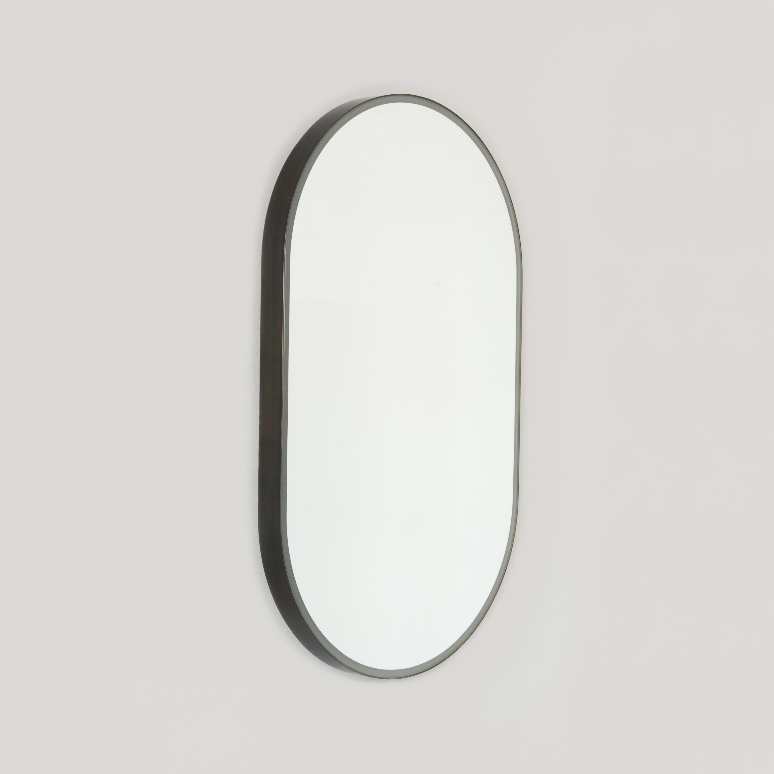 Capsula Illuminated Pill Shaped Mirror with Bronze Patina Frame, Medium In New Condition For Sale In London, GB