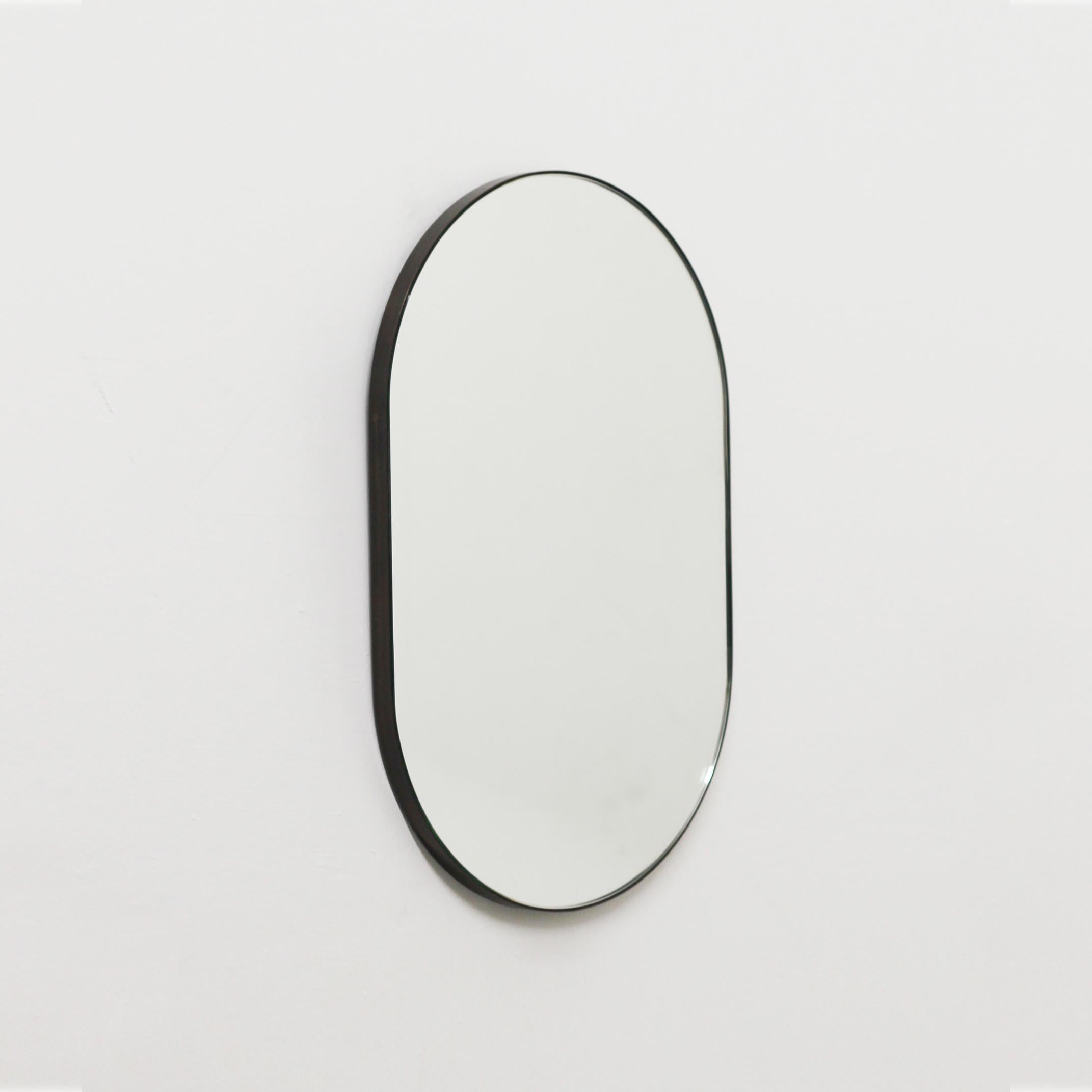Contemporary Capsula™ capsule / pill shaped mirror with a bronze patina brass frame. Designed and handcrafted in London, UK.

Our mirrors are designed with an integrated French cleat (split batten) system that ensures the mirror is securely mounted