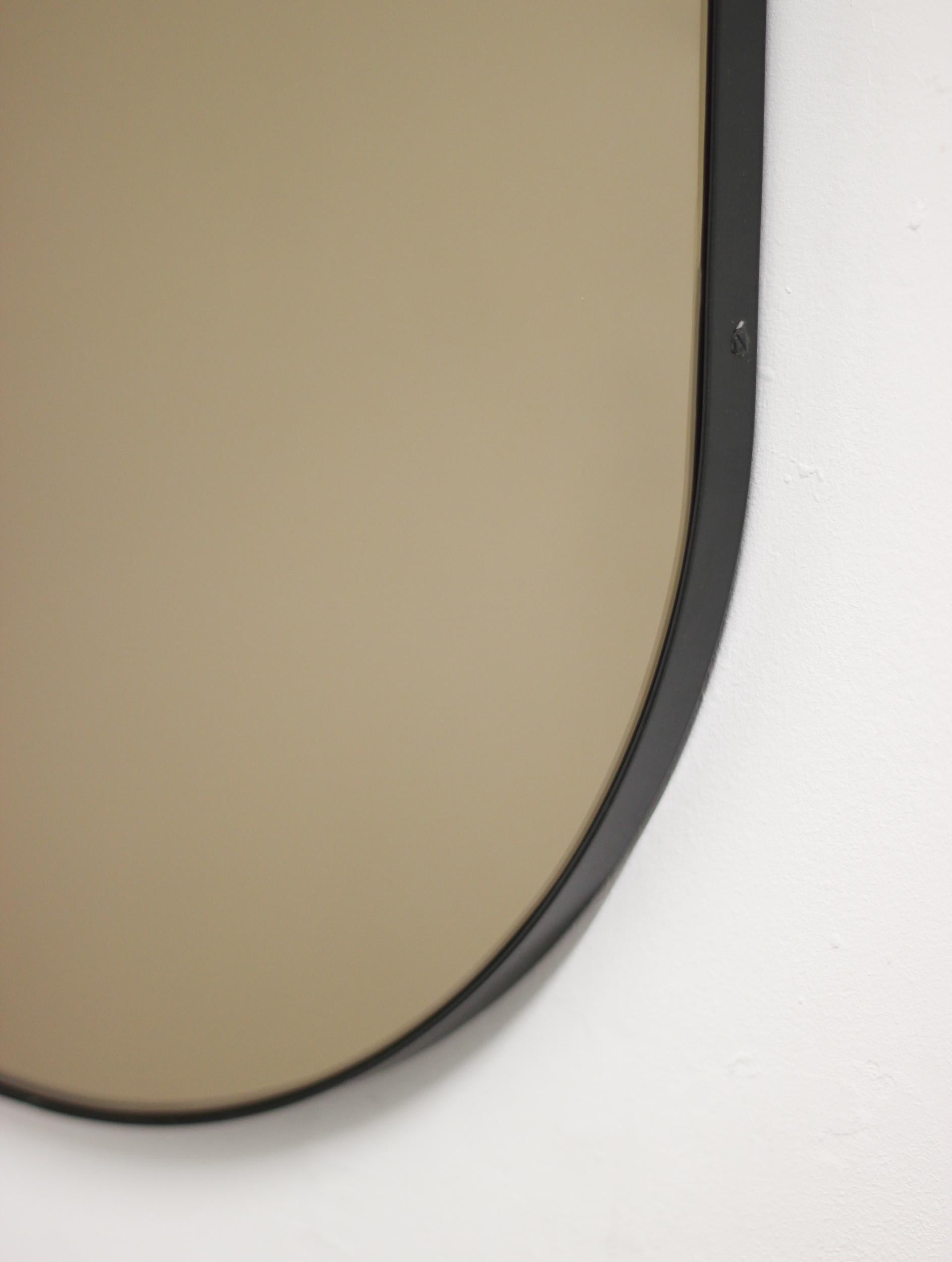 British Capsula Capsule shaped Bronze Modern Mirror with Black Frame, Medium For Sale
