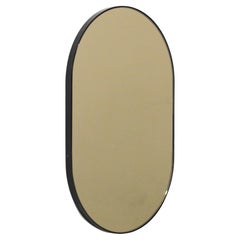 Capsula Capsule shaped Bronze Modern Mirror with Black Frame, Medium