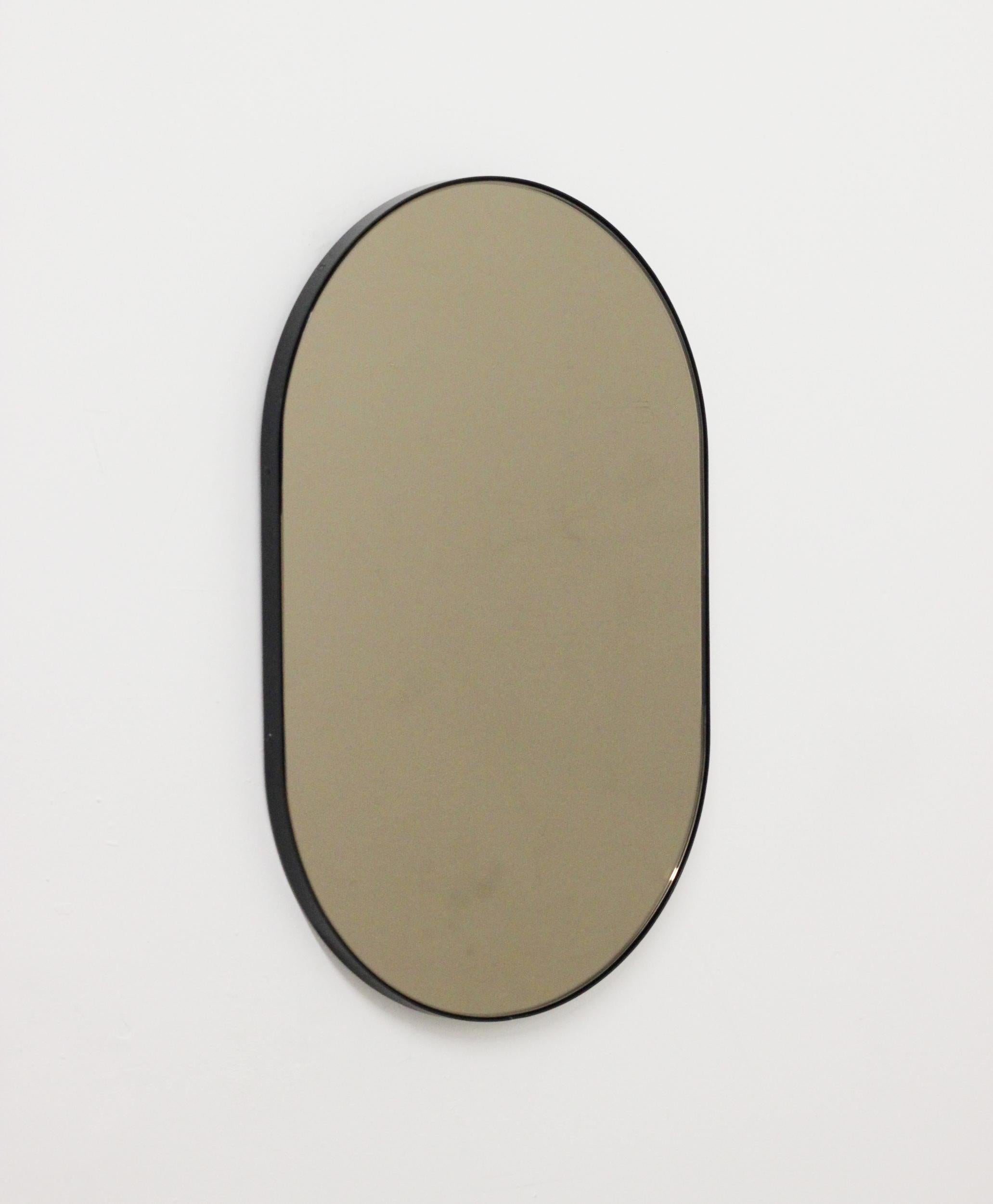 Powder-Coated Capsula Capsule shaped Bronze Contemporary Mirror with Black Frame, Large For Sale