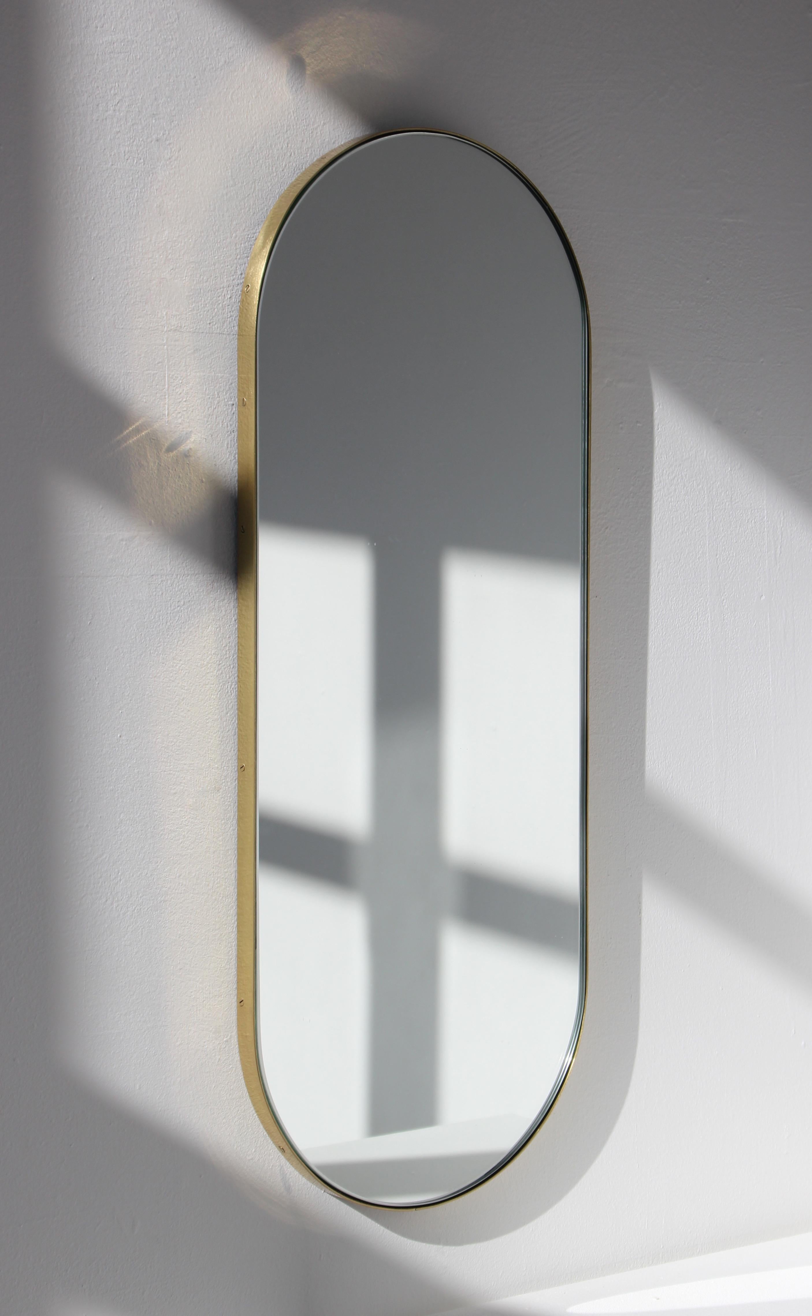 Delightful capsule shaped mirror with an elegant solid brushed brass frame. Designed and handcrafted in London, UK.

Medium, large and extra-large (37cm x 56cm, 46cm x 71cm and 48cm x 97cm) mirrors are fitted with an ingenious French cleat (split