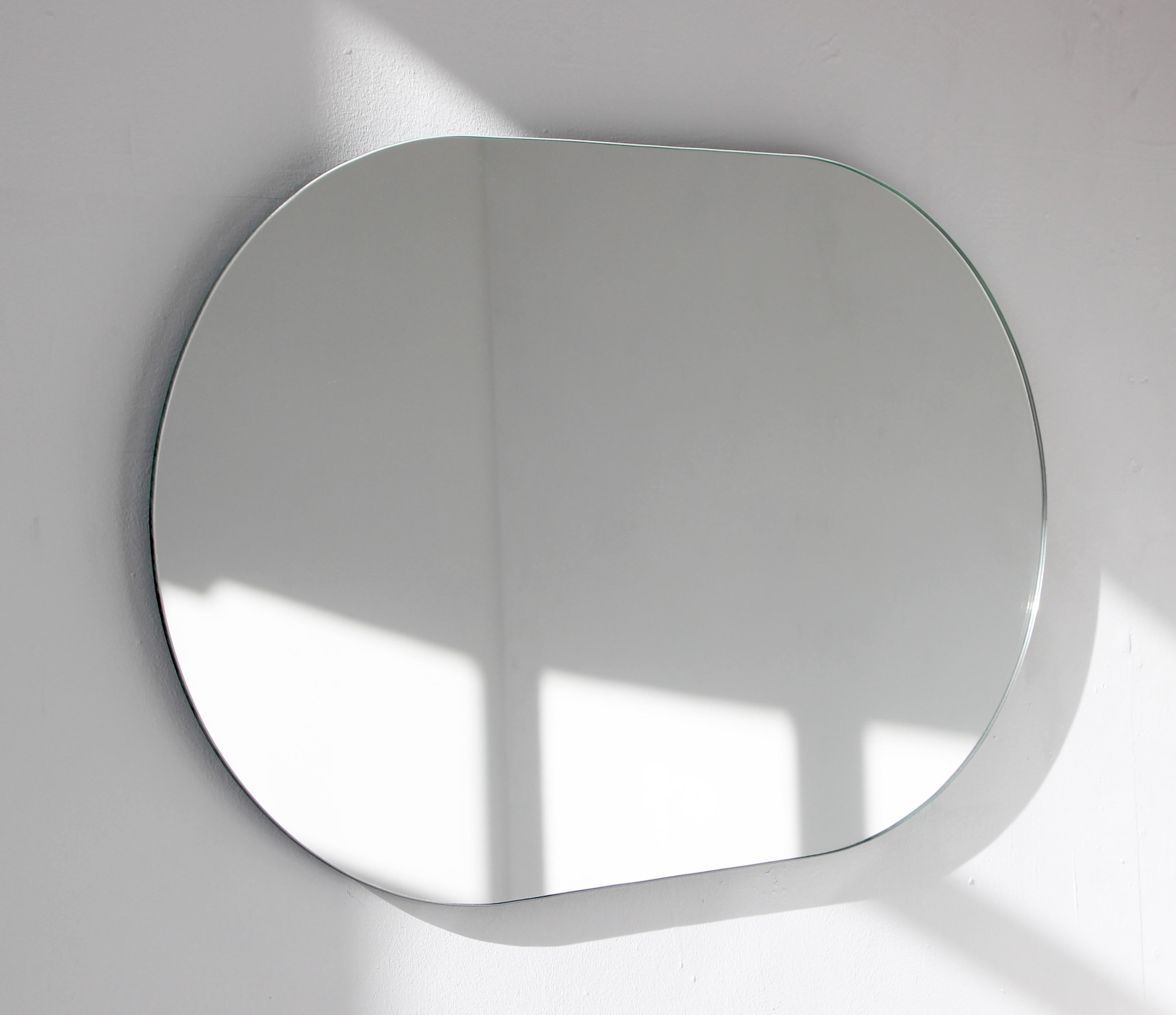 Minimalist capsule shaped frameless mirror. Quality design that ensures the mirror sits perfectly parallel to the wall. Designed and made in London, UK.

Fitted with professional plates not visible once installed for an easy and safe installation.