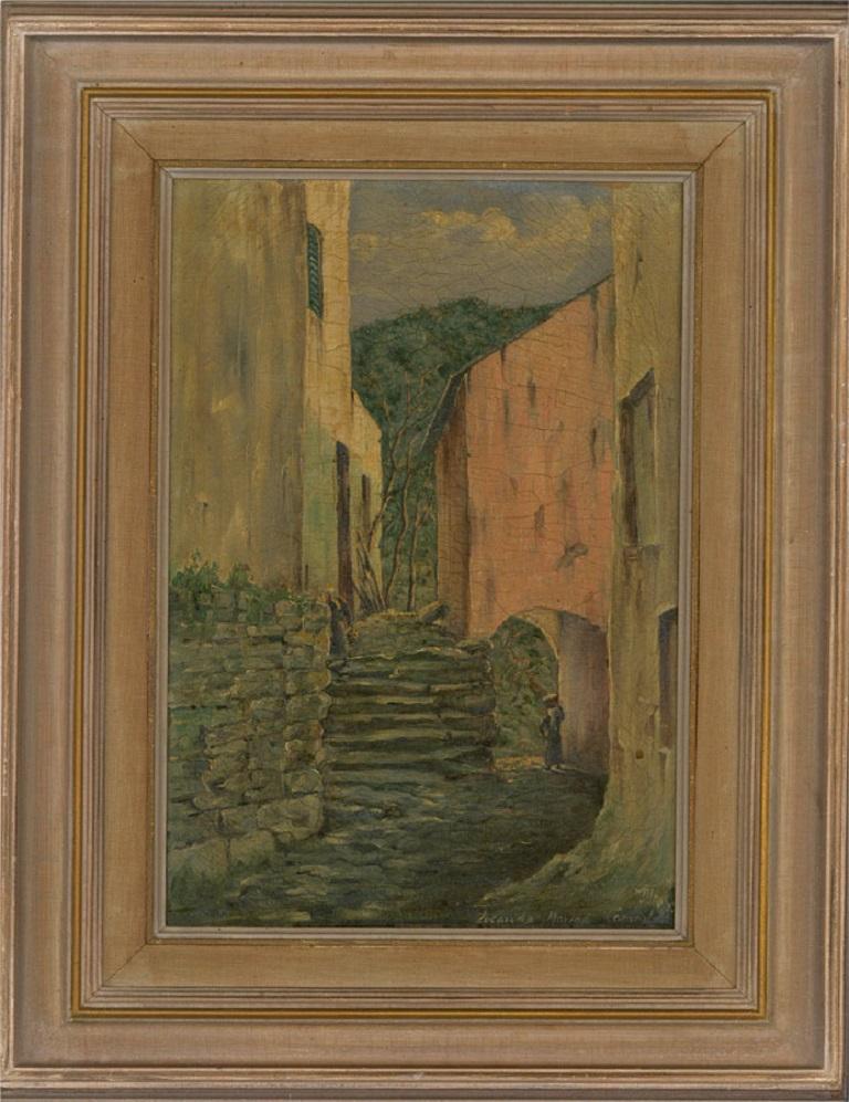 A view down a historic cobbled street in the fishing village of Camogli in northern Italy. Presented in a grey painted wooden frame with gold detailing and a linen inner window. Monogrammed, dated, and inscribed with the title to the lower-right