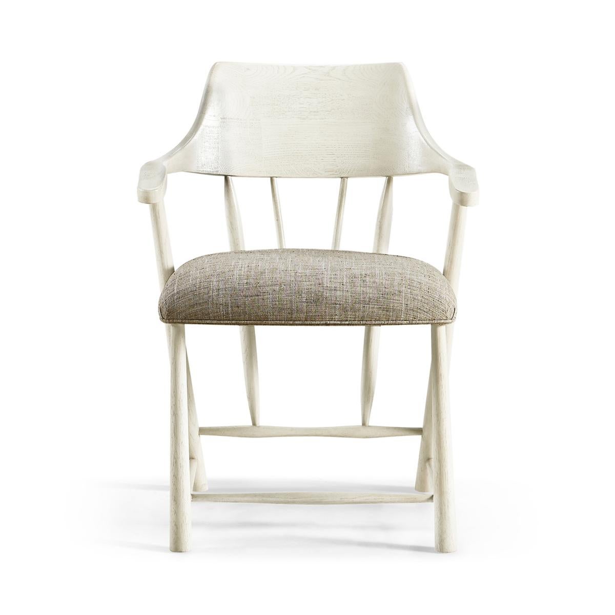 Captain's armchair - references to modern stylings and Scandanavian sentiments. The solid hardwood frame is finished in zinc white with interlocking supports for a clean and minimal aesthetic. An upholstered seat covered in Kravet fabric provides