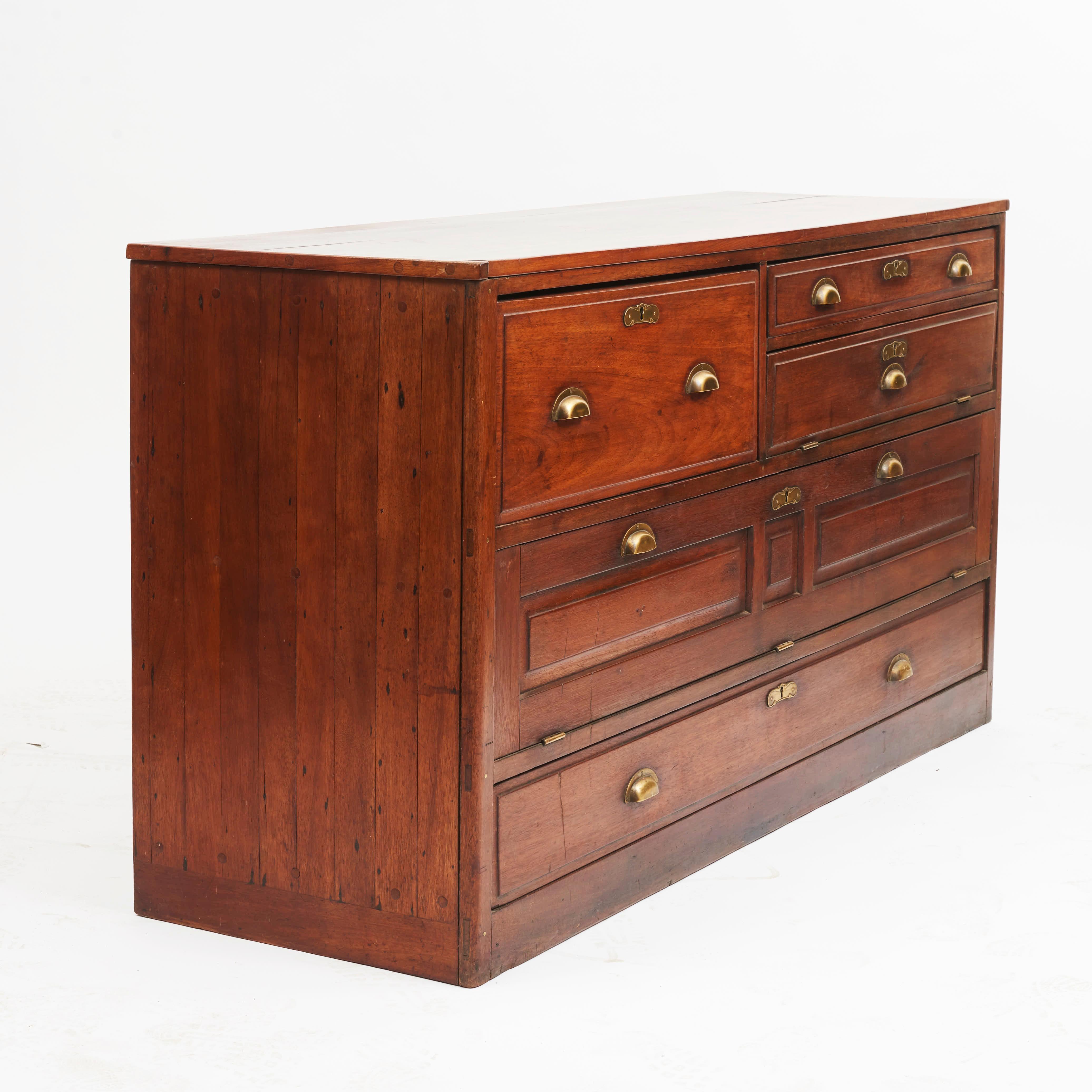 Ships chest of drawers in solid mahogany with original brass handles and locks.
Flaps and drawers used for storage of nautical chart etc.

Originated from the schooner F.F. Nicobar. 
Presumably made in England, dating back to the late 19th