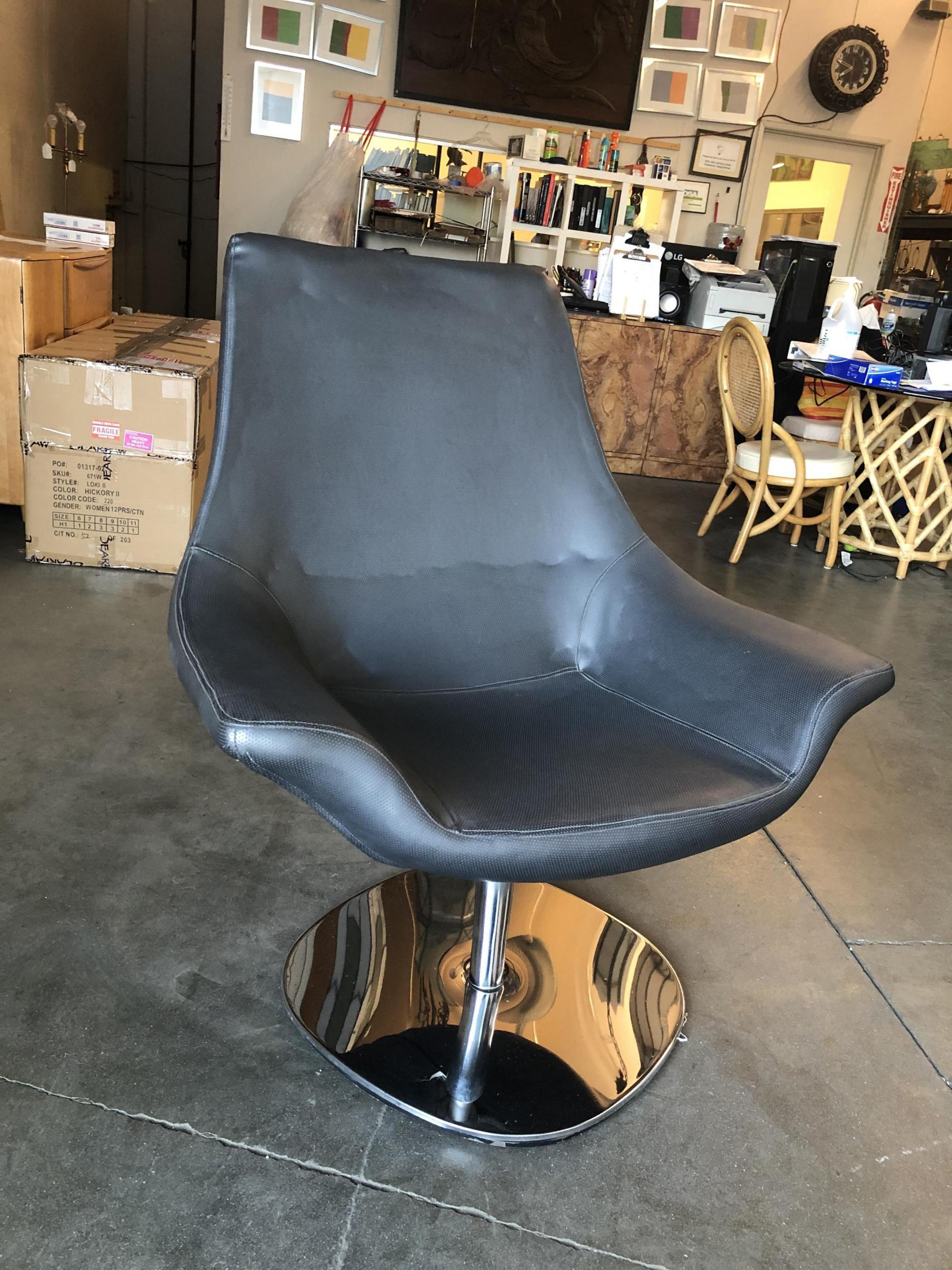 Very modern Futurist Italian faux leather captain's lounge chair with a chrome base. This chair would look great in a Memphis-style room, circa late 1980s.