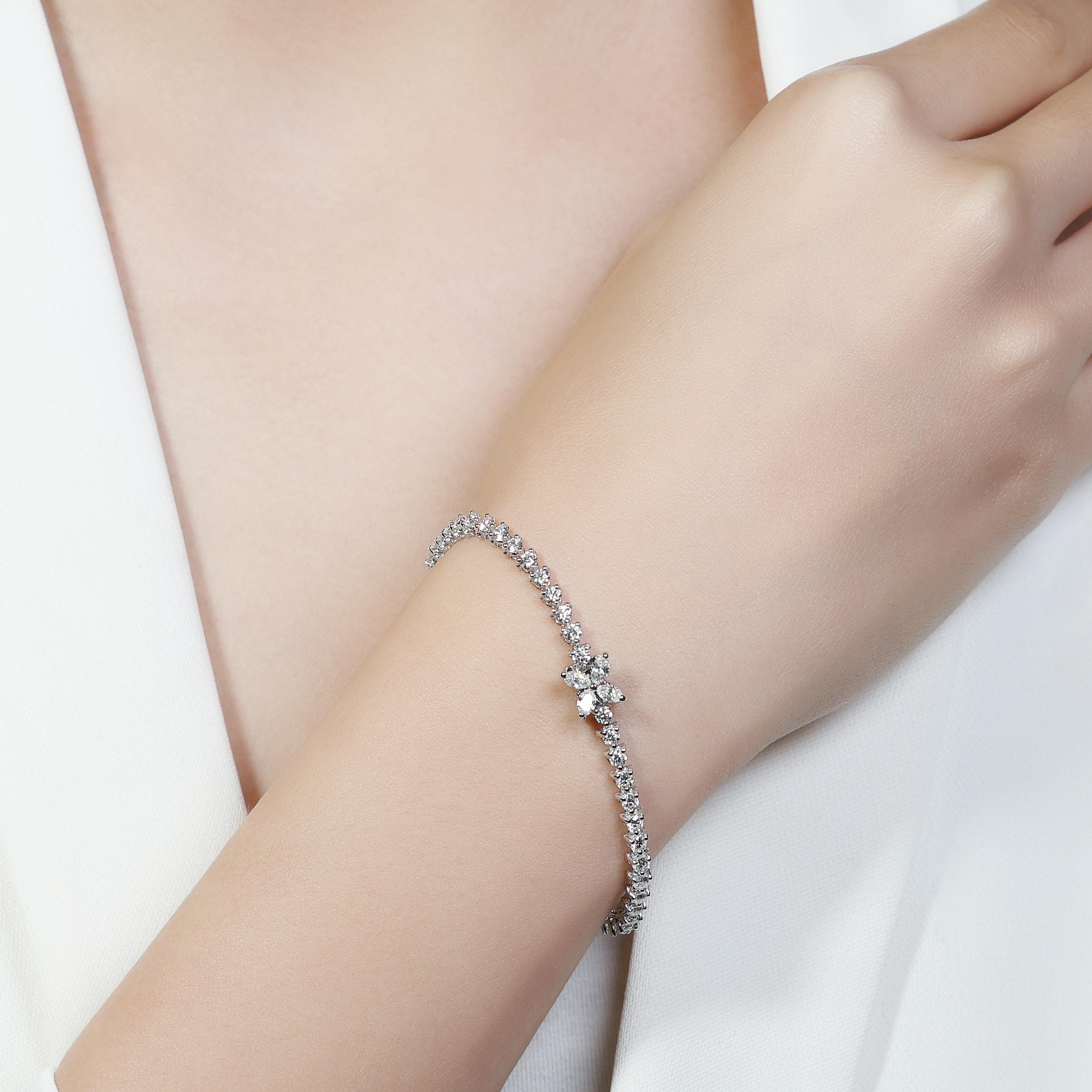 Crafted from sleek and durable 18k white gold, it offers a lustrous setting that beautifully highlights the brilliance of its diamonds. With a total of 53 meticulously selected stones, this piece is designed to sparkle with every movement, making it