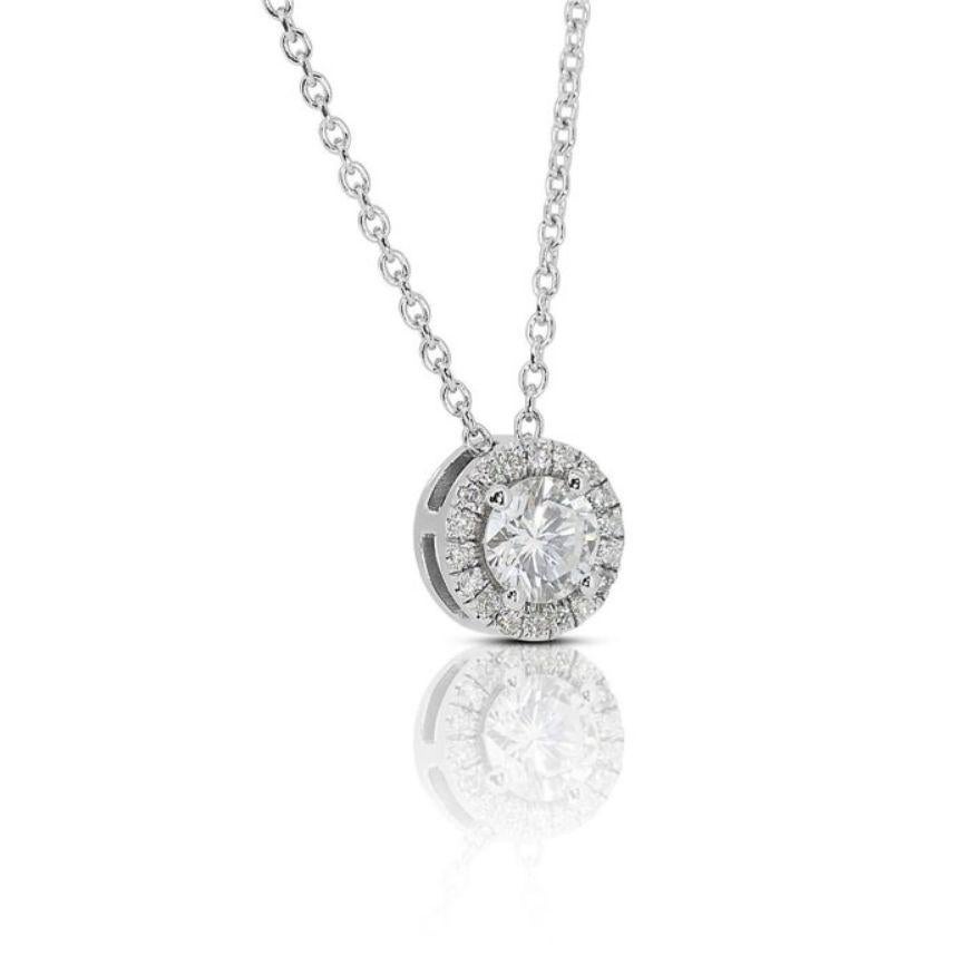 Embrace brilliance with this breathtaking necklace, showcasing a dazzling 0.52 carat Round Brilliant diamond, meticulously set in gleaming 18K white gold. The exceptional D color (highest color grade!) and near-flawless VVS1 clarity of the center