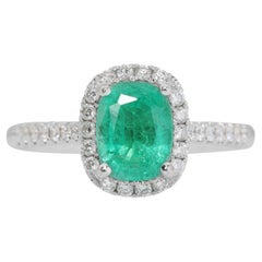 Captivating 0.69ct Emerald Ring with 0.29ct Diamond Side Stones