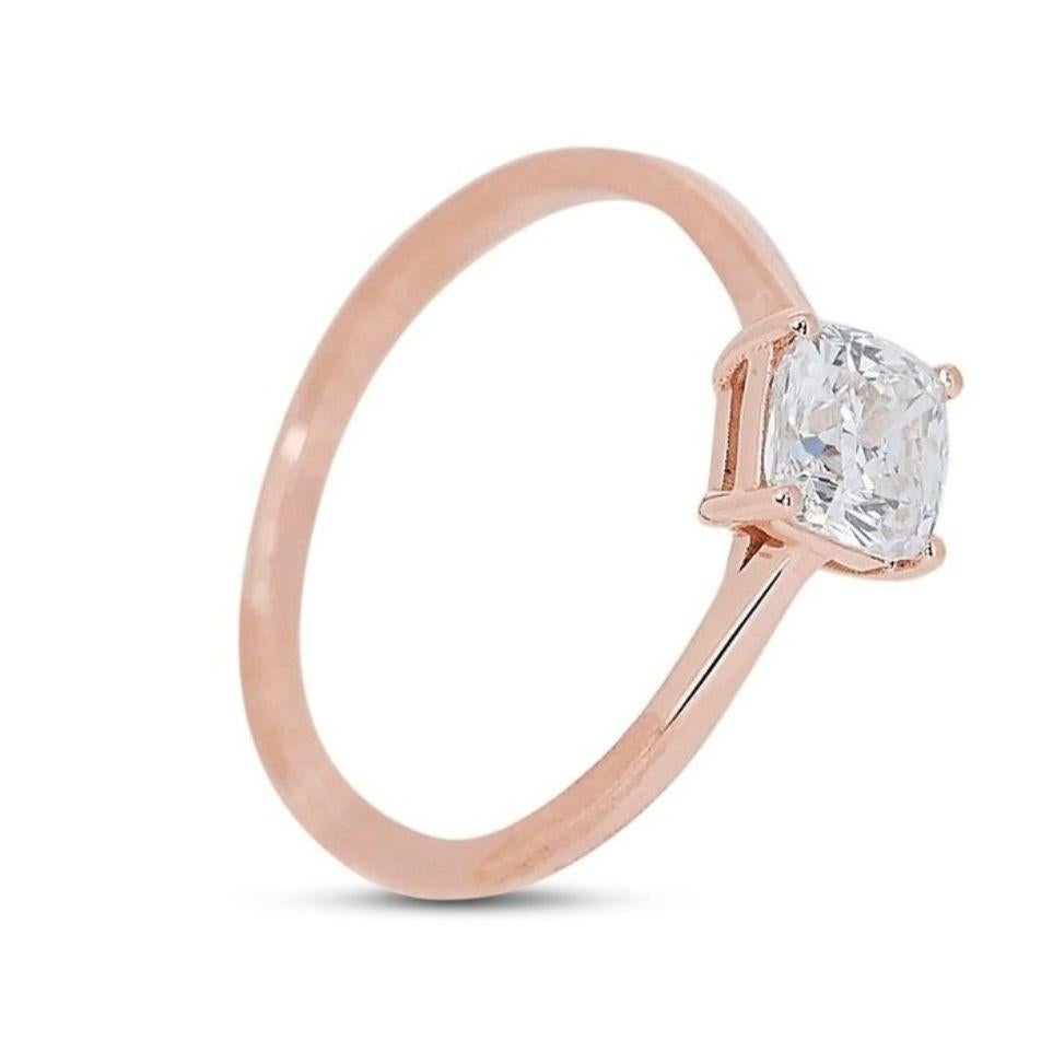 Embrace timeless romance with this captivating ring, showcasing a dazzling 0.9 carat cushion diamond nestled in luxurious 18K rose gold. The exceptional F color exudes a subtle warmth, complementing the rose gold setting beautifully, while the SI1