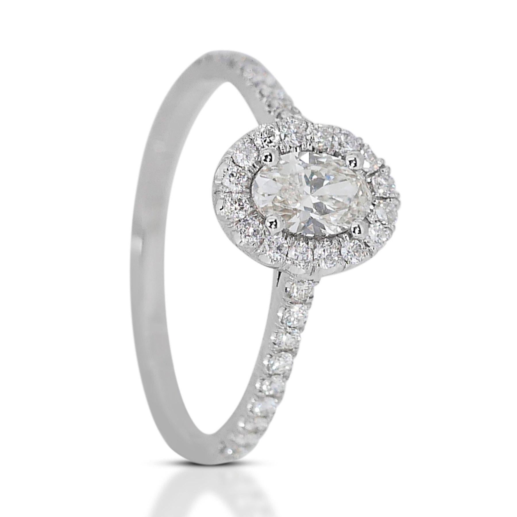 Captivating 1.01 ct Oval Diamond Halo Ring in 18k White Gold – GIA Certified

This exquisite diamond halo ring, set in polished 18k white gold, showcases a stunning 0.71-carat oval main diamond. Surrounding the main stone, 34 round diamonds totaling