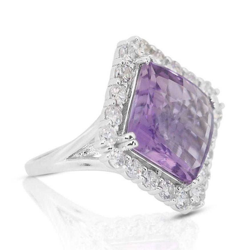 This captivating ring features a magnificent square cushion mixed-cut amethyst as its centerpiece, boasting an impressive weight of 10.56 carats. The rich purple hue of the amethyst exudes elegance and allure, capturing the eye with its vibrant