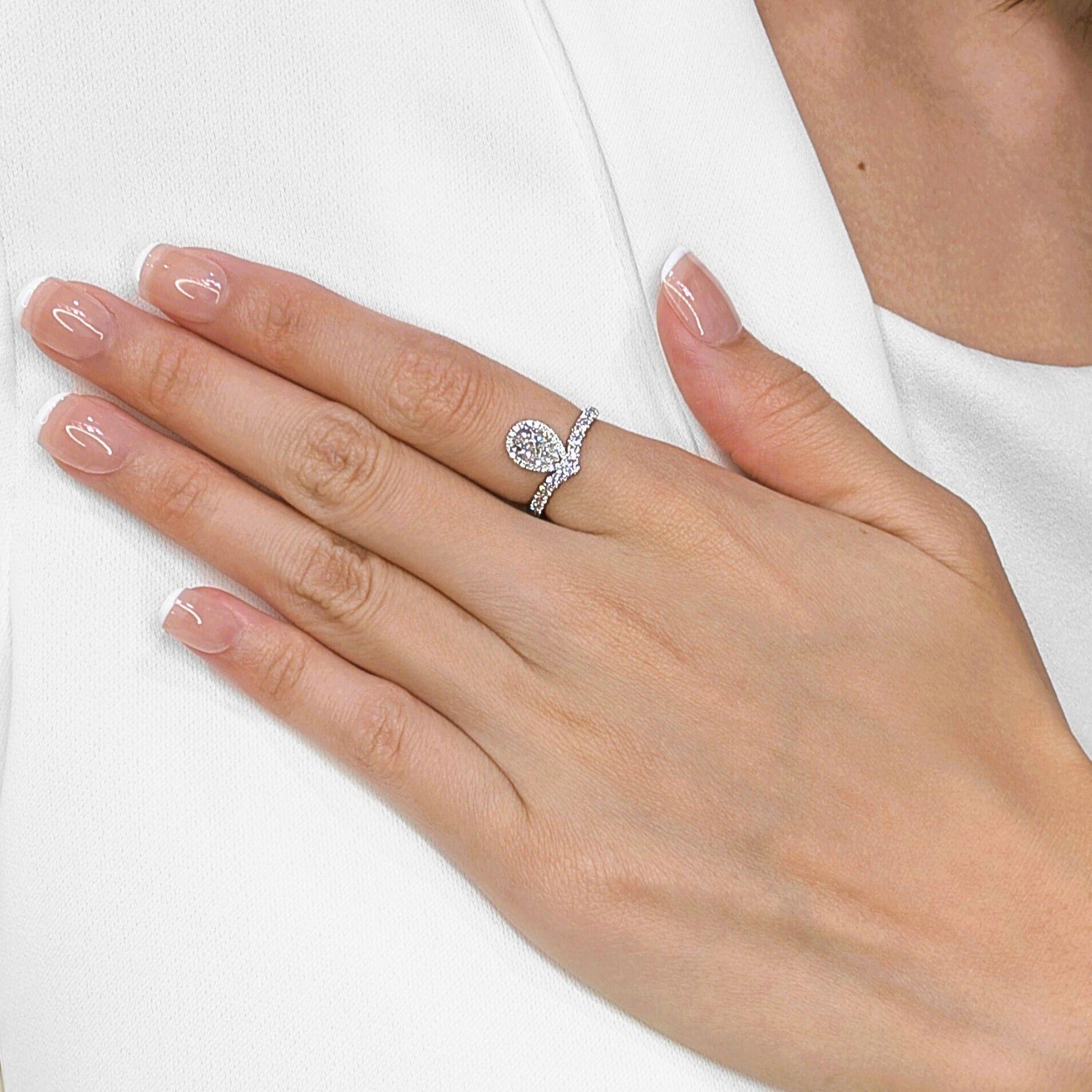 Propose with undeniable elegance with this stunning engagement ring, meticulously crafted in enduring Platinum 950. At its heart, a magnificent 0.71ct natural pear-shaped diamond radiates with exceptional F color and impressive VS1 clarity, ensuring