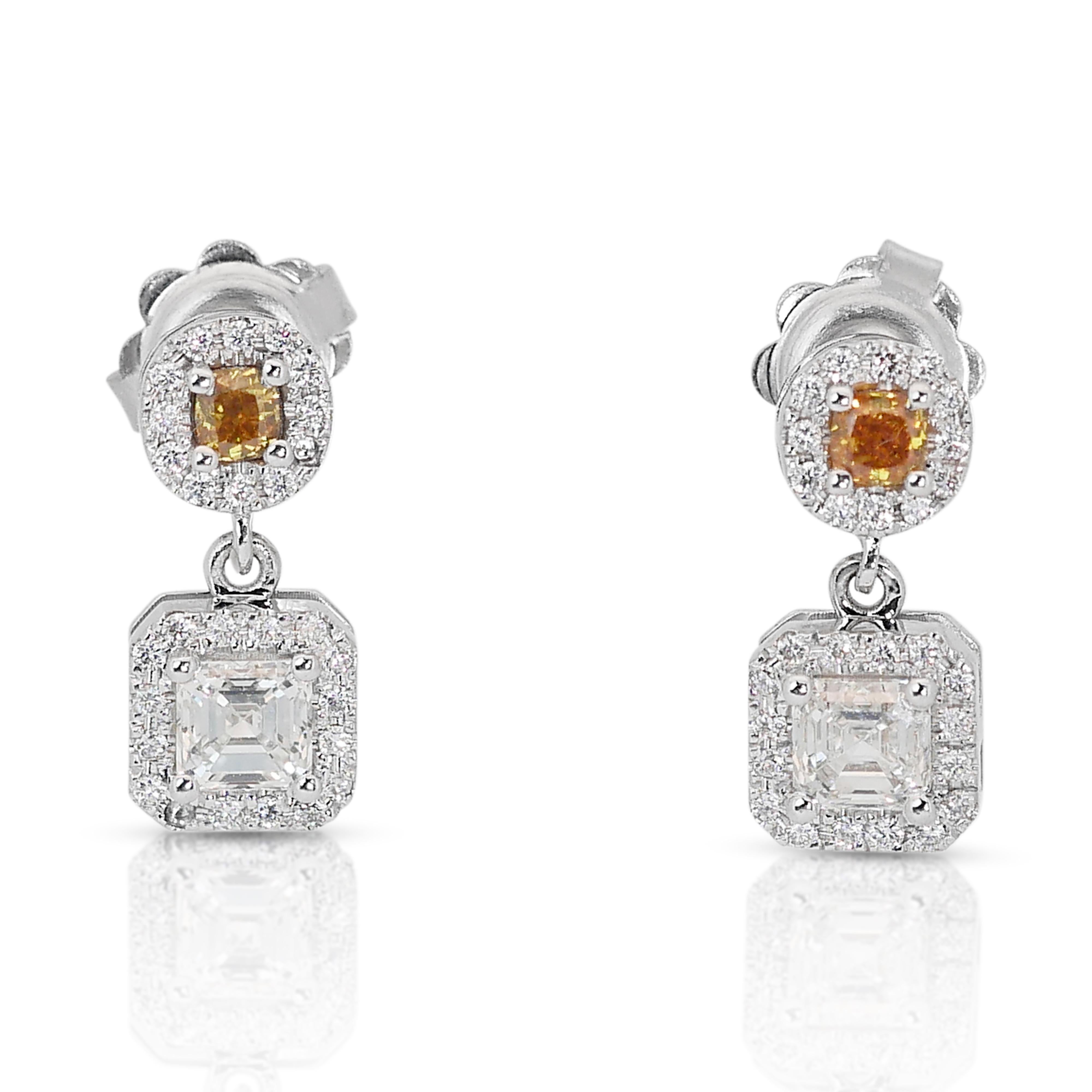 Discover the epitome of elegance with these exquisite 14k white gold drop earrings, featuring a mesmerizing array of diamonds. Anchored by 2 square-cut main diamonds totaling 0.80 carats. Complementing the main stones are 2 cushion-cut diamonds in