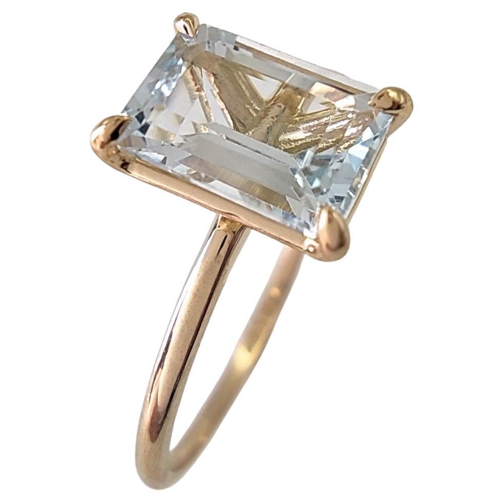 Captivating 18K Gold Solitaire Ring featuring a 0.83 Ct. Emerald-Cut Aquamarine For Sale