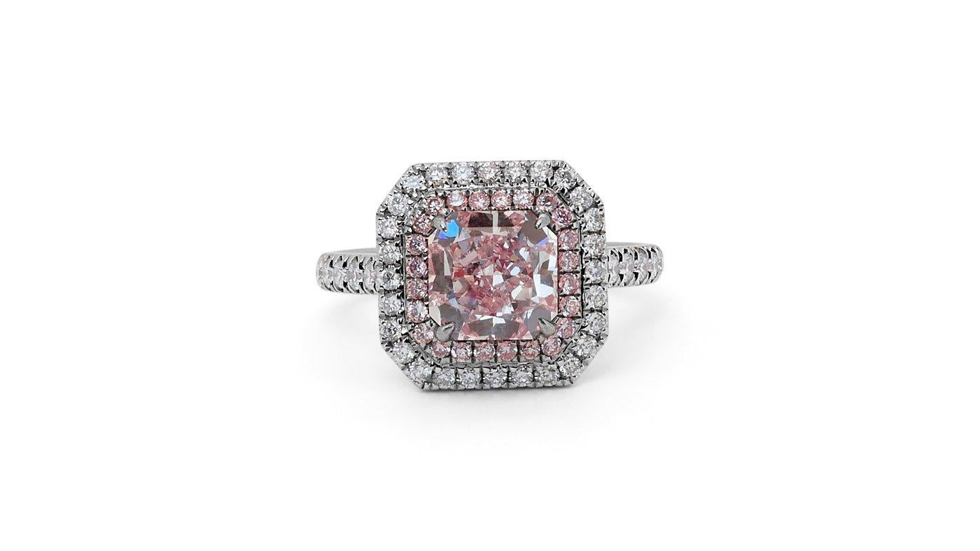 A beautiful and rare Pink Diamond Halo Ring with a Beautiful Natural Square Radiant Light Pink Diamond with Vvs1 quality. Around the main pink diamond there is a raw of light fancy pink diamonds with a total of 0.20 carat total with VS quality. Then