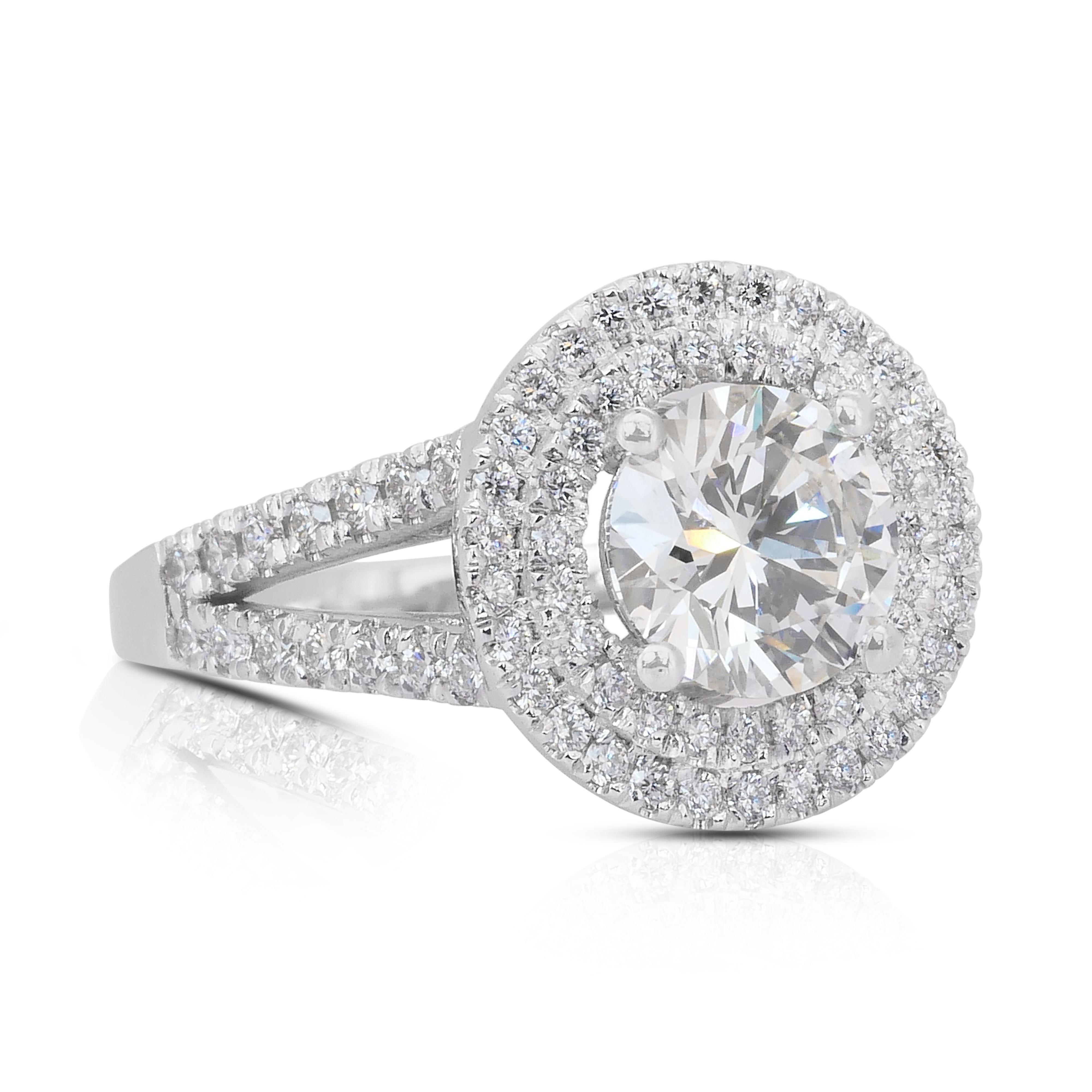 Captivating 2.26ct Diamonds Double Halo Ring in 18k White Gold - IGI Certified

This luxurious ring centers a dazzling 1.50ct round diamond with a captivating sparkle. Surrounding it are 81 meticulously set round diamonds with 0.76ct total,