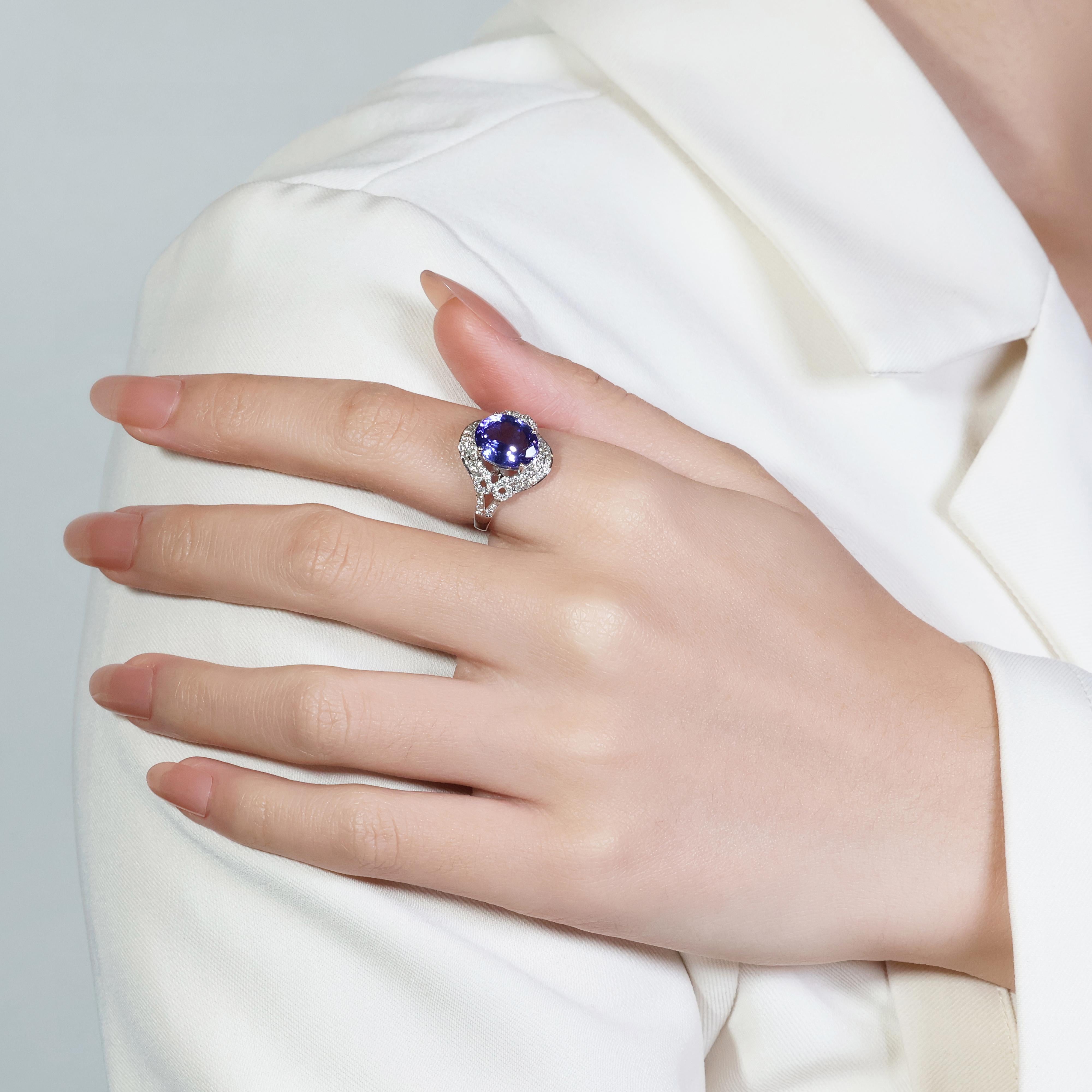 Immerse yourself in captivating color with this mesmerizing tanzanite and diamond ring! This exquisite 18K white gold ring showcases a stunning 3.373-carat oval-cut tanzanite gemstone, boasting a captivating play of blue and purple hues. This new,