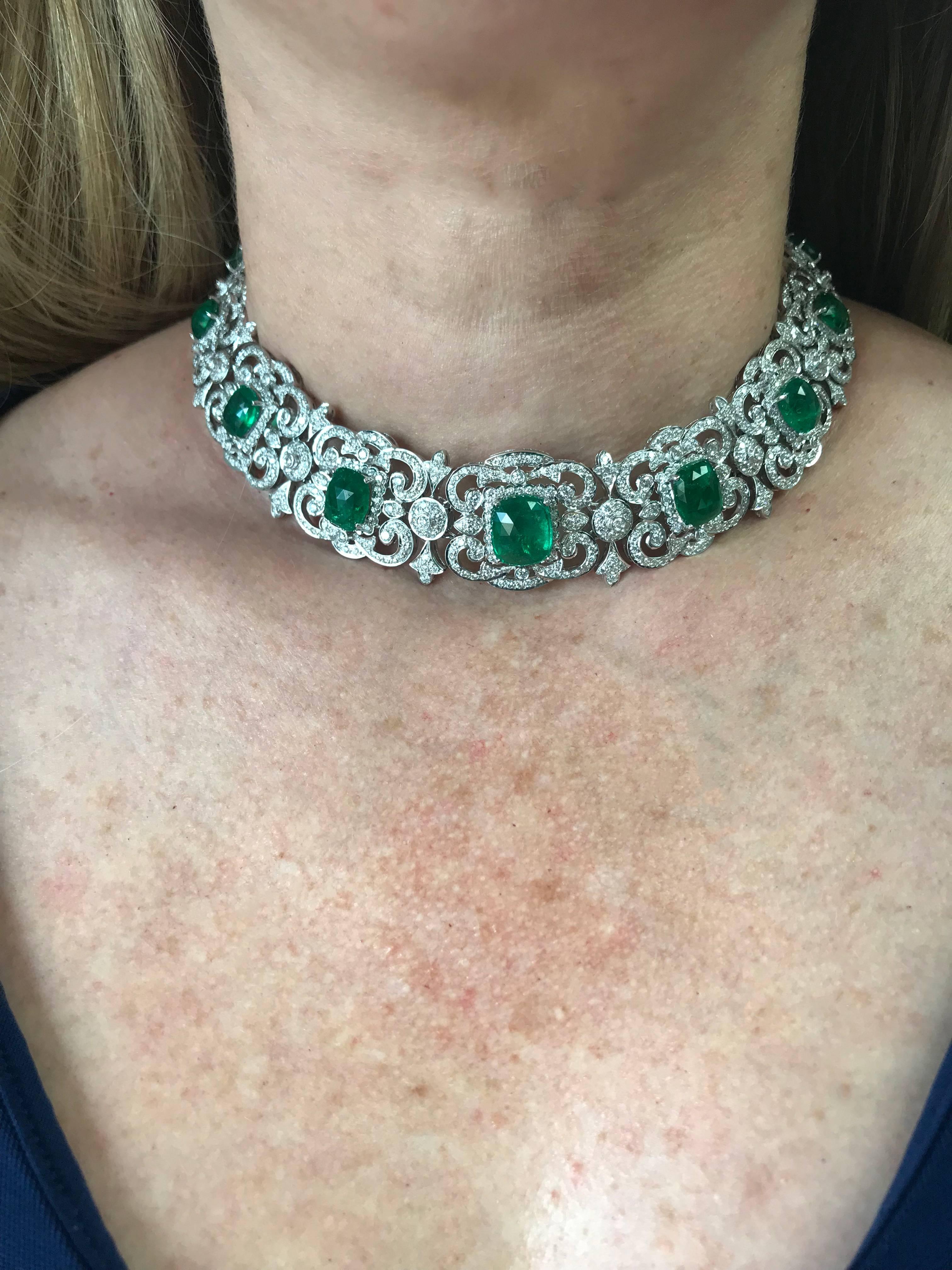This breathtaking 18K white gold necklace and earring set contains 11 faceted cabochon emeralds weighing approximately 32cts accented by 12.02ct of round brilliant cut diamonds G-H color and VS clarity. Each one of these vibrant Emeralds rests