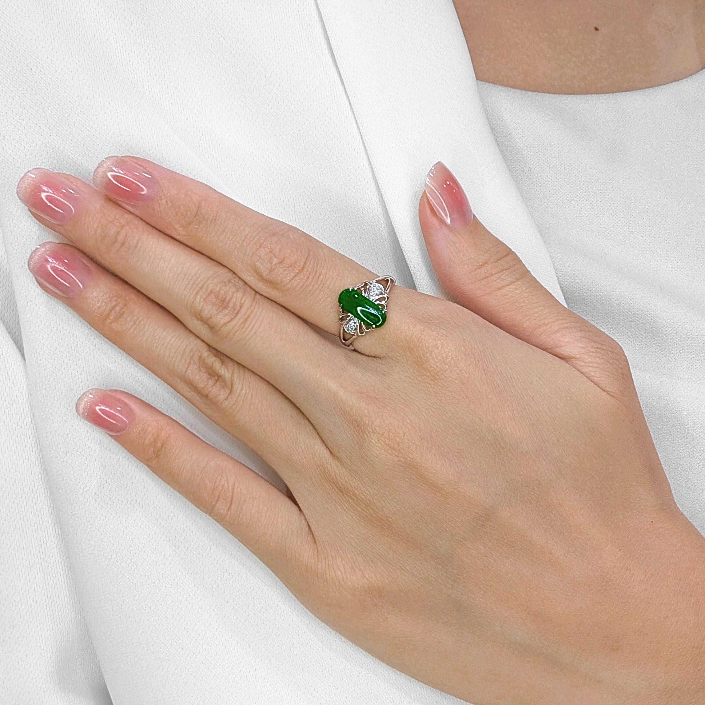 A symbol of grace and prestige, this exquisite ring features a vibrant green jade, radiating timeless elegance and cultural significance. Set in 18K white gold, its refined design is elevated by six round brilliant diamonds, totaling 0.03ct with H