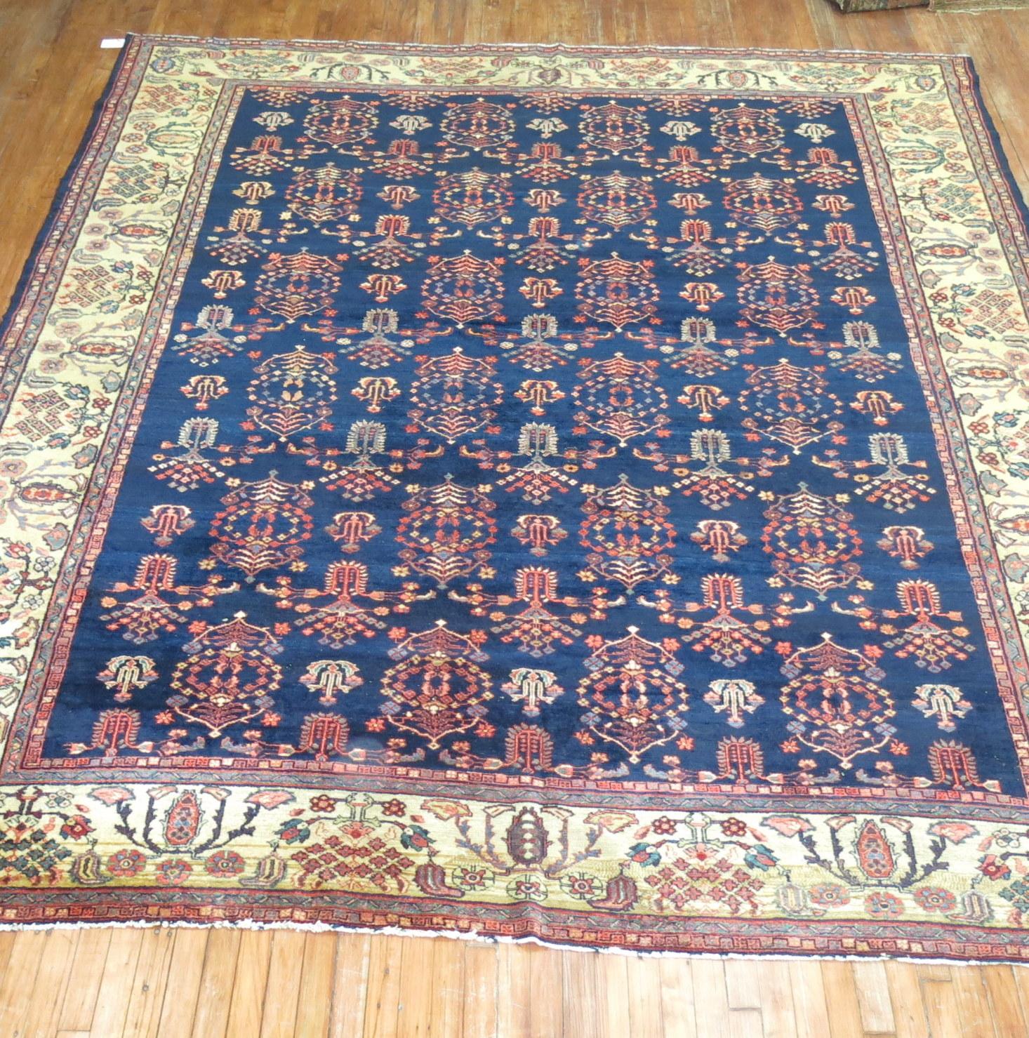 An authentic early 20th-century Sarouk Ferehan navy blue field carpet with an all-over geometric pattern
Measures: 9'5