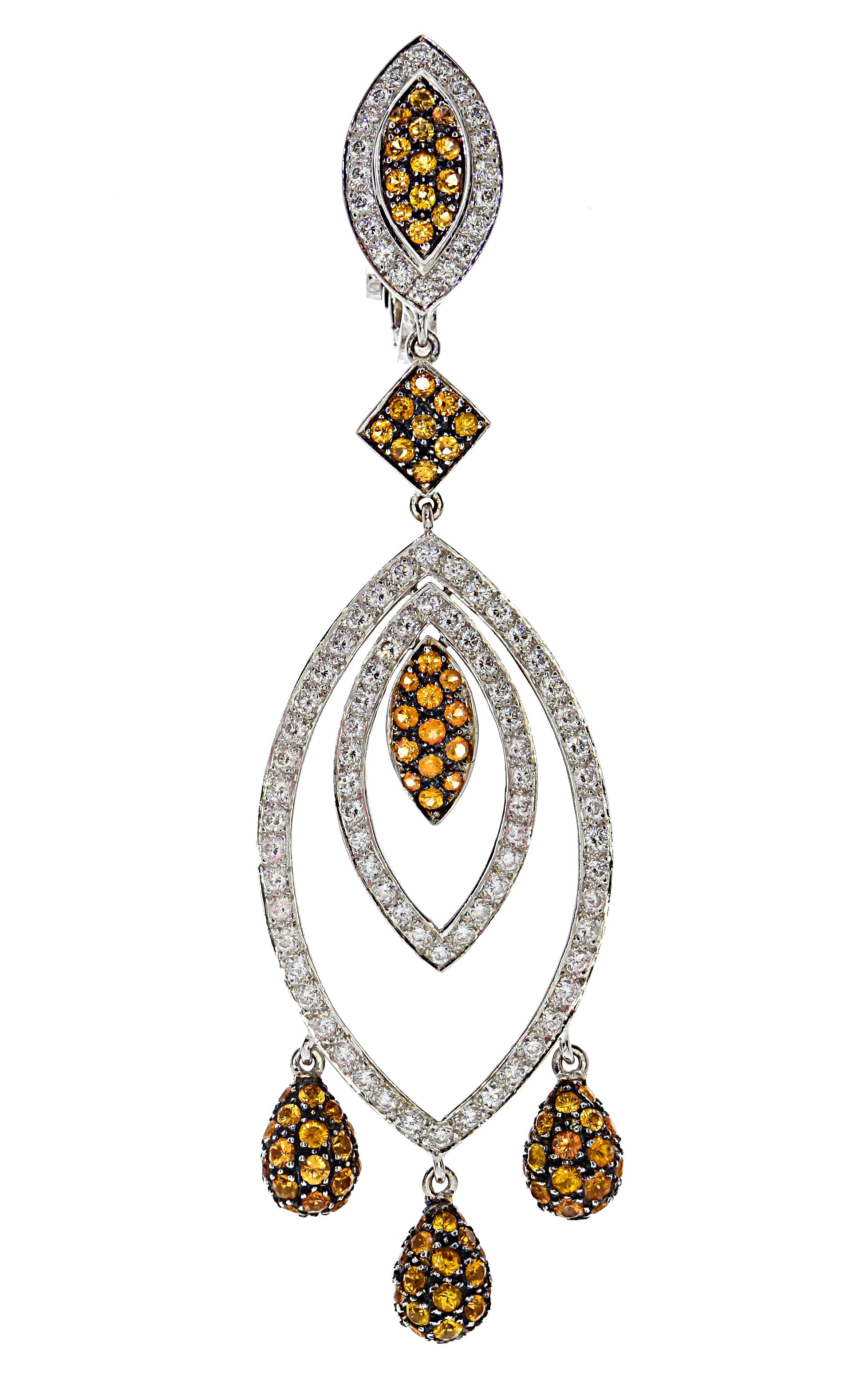 Captivating Chatila almond-shaped drop earrings made in 18 carat white gold and set with orange sapphires and sparkling white diamonds. Includes both 
clip-on and latch back enclosures.

Details:

-184 diamonds with a total weight of 1.79