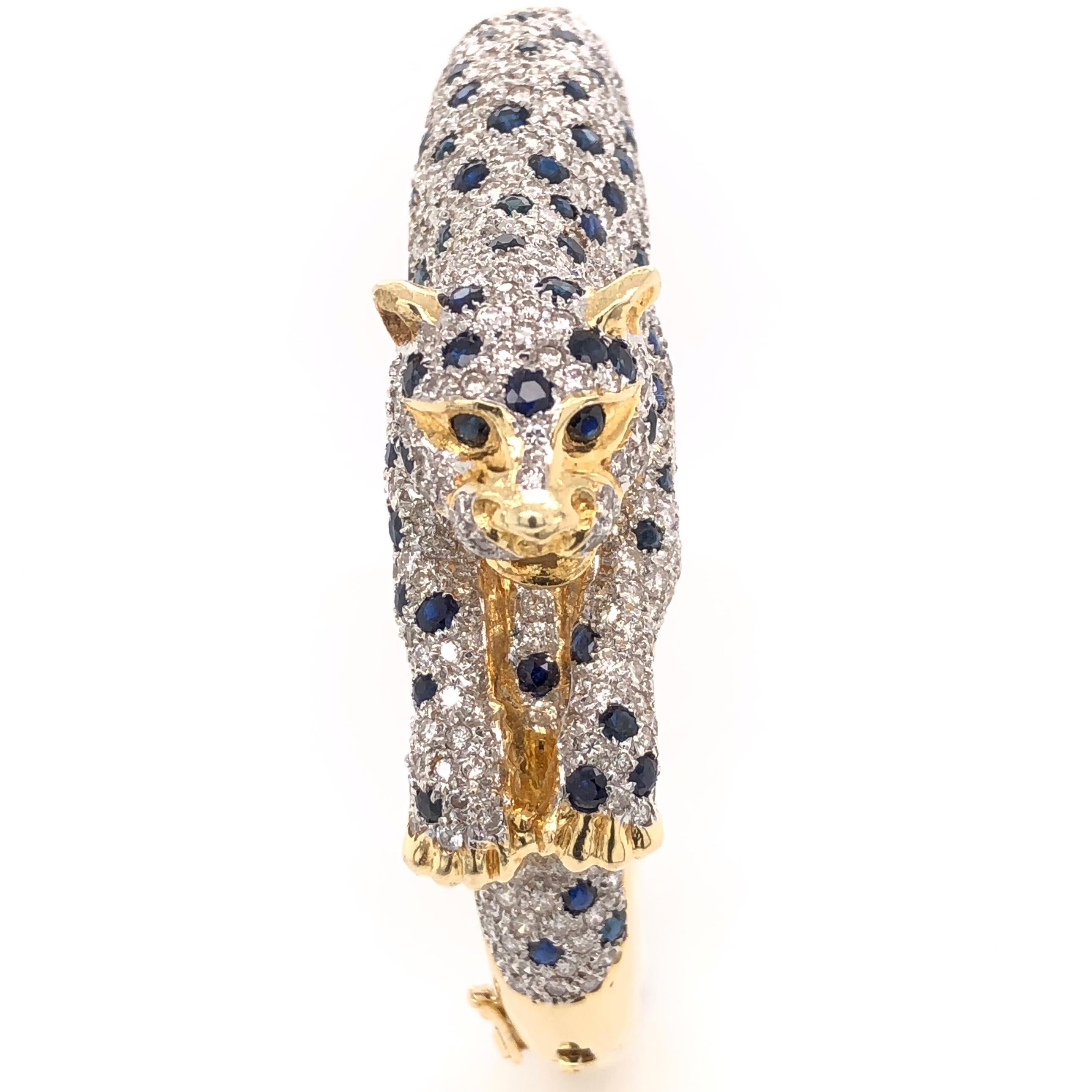 Stylish and Sinuous Diamond and Sapphire Panther Bangle Bracelet intricately designed and Hand crafted in 18K yellow gold with incredible detail and elegant design, using fine Gem stones and superior craftsmanship. Comprising: approx. 6.50 Carat