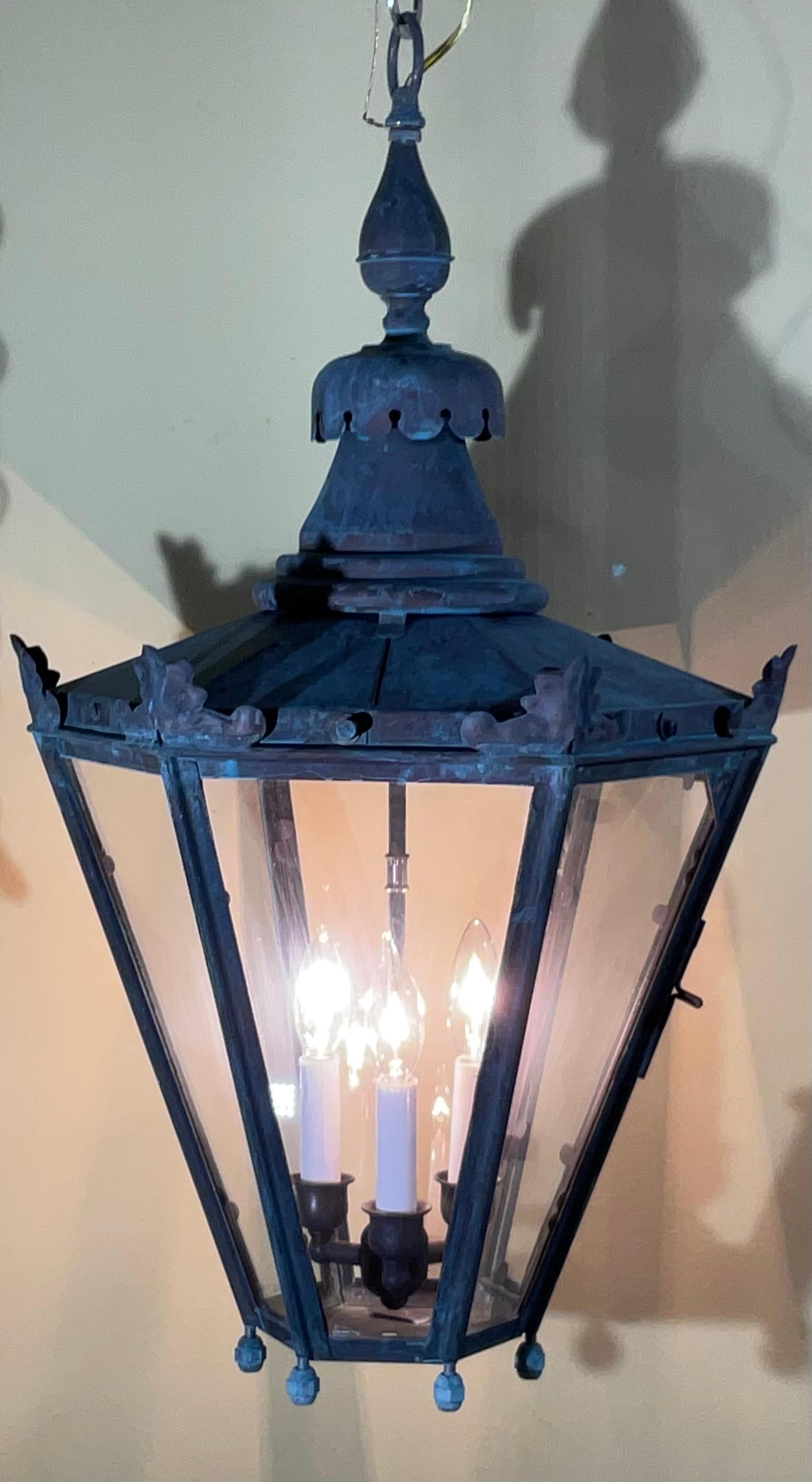 Illuminate your home or outdoor space with the timeless elegance of this substantial vintage hanging lantern. Crafted from a rich blend of solid brass and copper, this impressive light fixture exudes character and sophistication, hinting at a bygone