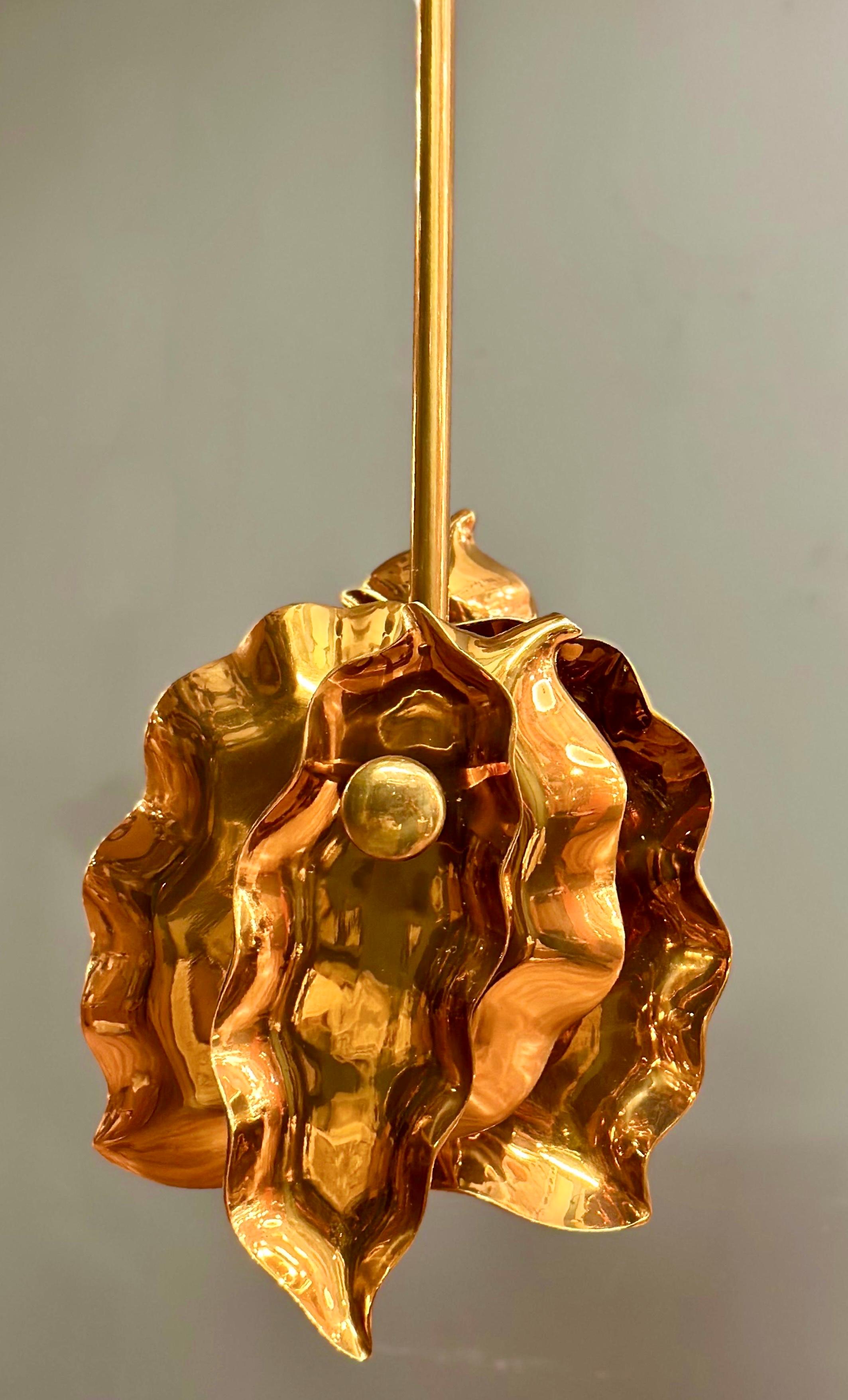 CAPUA pendant stands as a testament to the seamless fusion of artistic ingenuity and natural inspiration, elevating your living space with its captivating botanical allure. Crafted with precision from a basting cast cluster, this pendant artfully