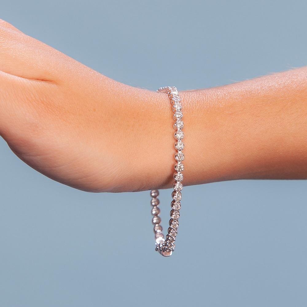 Beautiful Diamond Tennis Bracelet. A staple in your jewelry collection. Handmade in New York. This tennis Bracelet showcases a delicate box chain embellished with dozens of shimmering white diamonds. Quality to us is important and that is why we