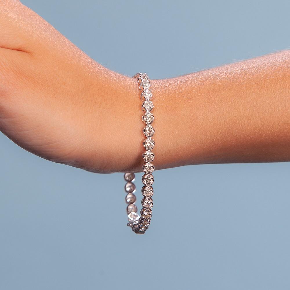 Beautiful Diamond Tennis Bracelet. A staple in your jewelry collection. Handmade in New York. This tennis Bracelet showcases a delicate buttercup chain embellished with dozens of shimmering white diamonds. Quality to us is important and that is why