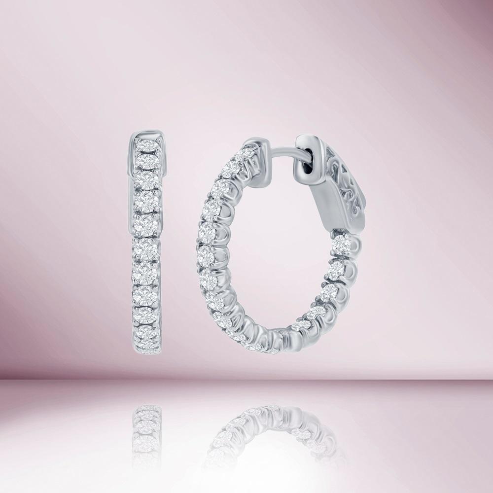 These Diamond Inside-Out Hoop Earrings are a stunning piece of jewelry that will elevate any outfit. Crafted in 14K gold, these earrings feature a total of 1.50 carats of sparkling diamonds set on both the inside and outside of the hoop.
The