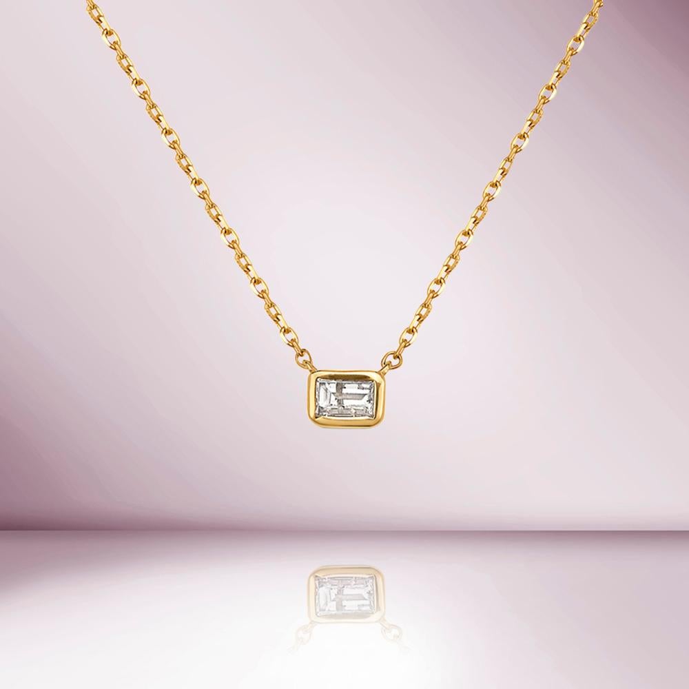 The Emerald Cut Diamond Solitaire Necklace is a classic and elegant piece of jewelry that is perfect for adding a touch of luxury and sophistication to any outfit. Featuring a beautiful emerald-cut diamond weighing 0.20 carats, the diamond is