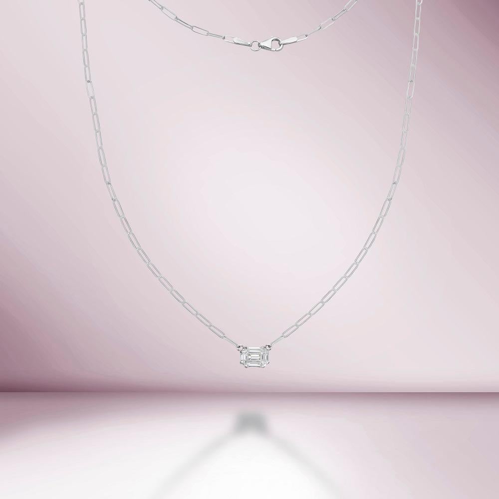 An Illusion Rectangular Shape Emerald Cut Diamond Paperclip Necklace refers to a necklace that combines the trendy paperclip chain design with a series of diamonds that create the illusion of an emerald cut. The term 