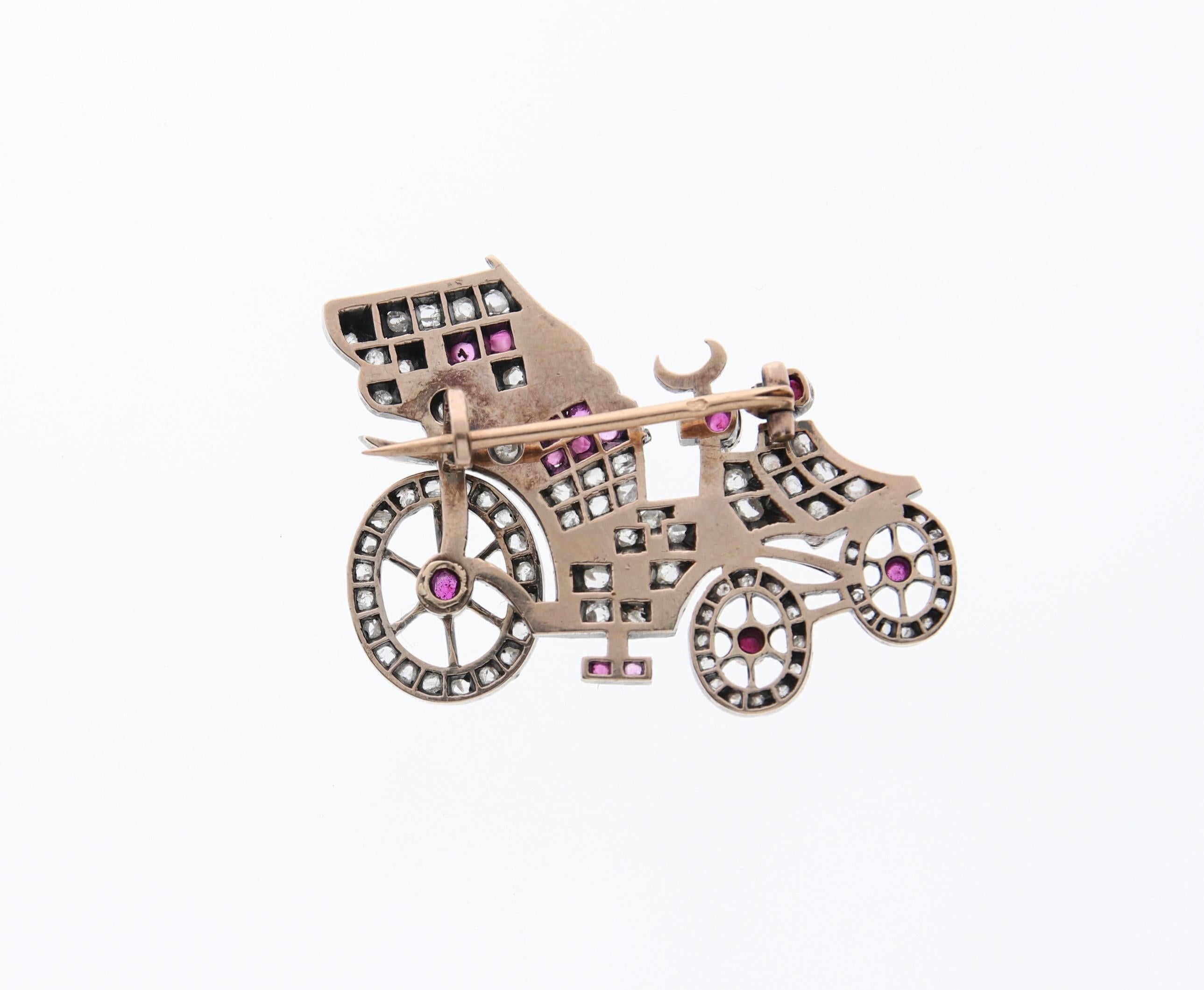 Detailed car carriage model ( e.g. Daimler or Aaglander) in silver on 18 KT yellow gold with rose cut diamonds and rubies cabochons. It has a french eagle head hallmark. 