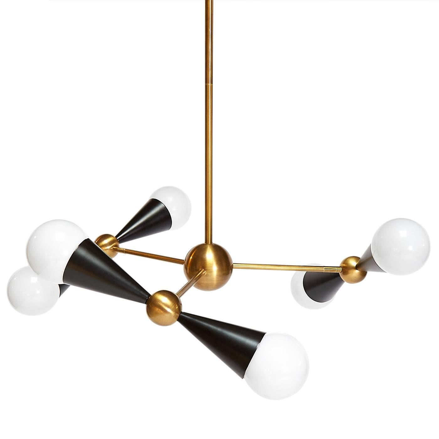 Kinetic modernism. Simple geometric shapes, cones and spheres, collide with dynamic results in our Caracas six-light chandelier. The three arms offer countless configurations, vertical for a classic vibe, horizontal for a more streamlined look, or