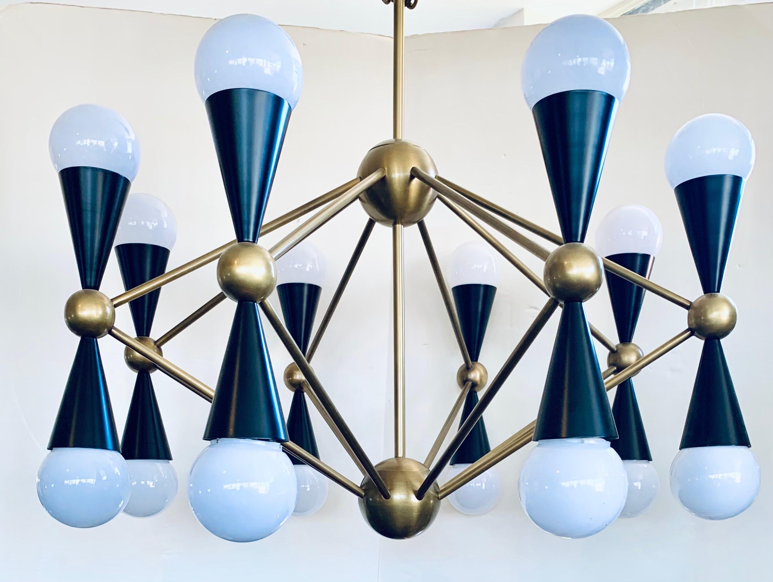 Eclectic mix of aesthetics can lead to some drop dead gorgeous lighting. Simple geometric shapes cones and spheres collide with dynamic results. Ideal scale for a dining room or a spacious foyer, the architectural Caracas sixteen-light chandelier