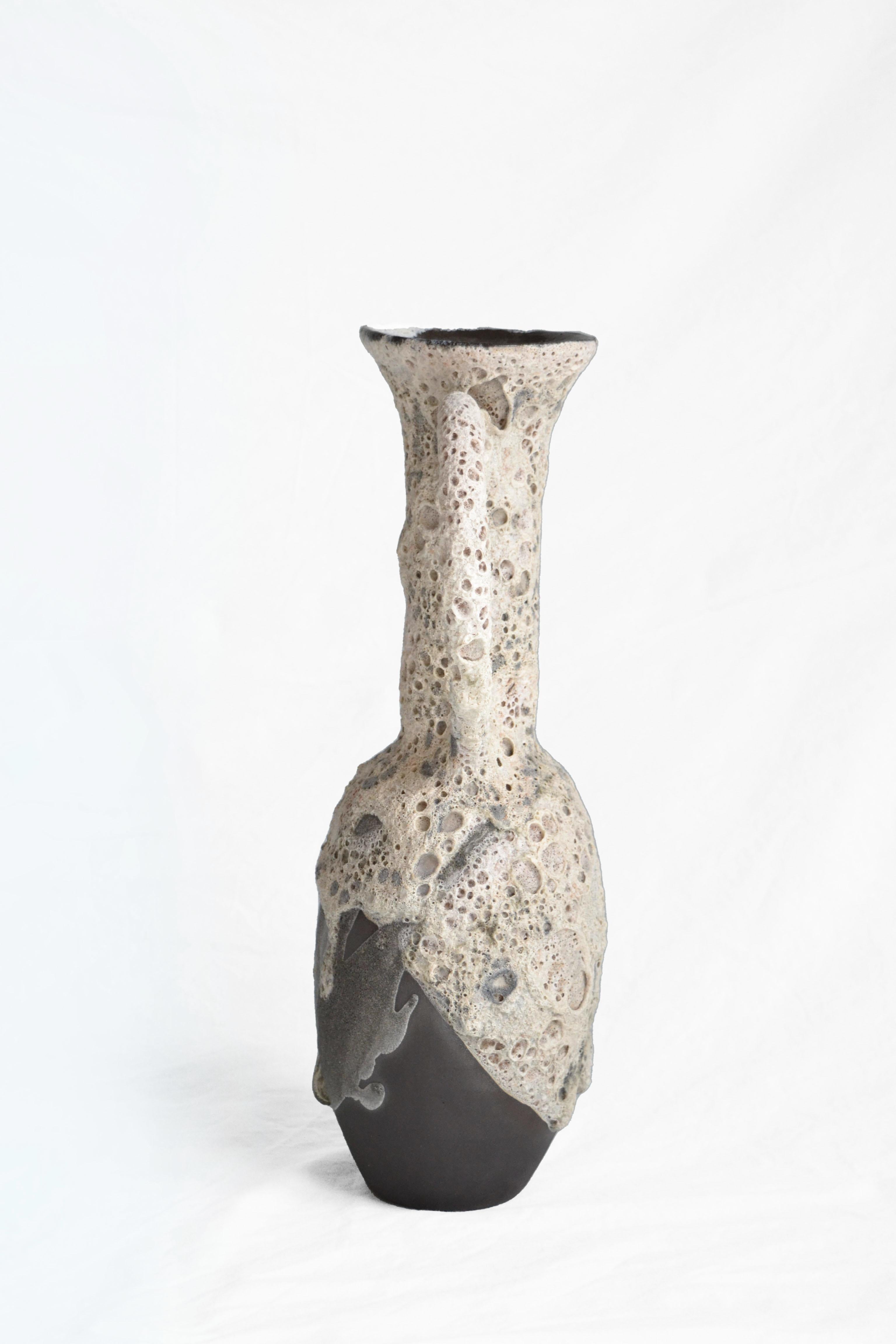 Carafe 1 vase by Anna Karountzou
Dimensions: W 26 x D 13 x H 40 cm
Materials: black stoneware clay, clear glaze inside, handmade crater glaze outside, fired at 1220

Born and based in Athens, Greece, with a background in conservation of works of